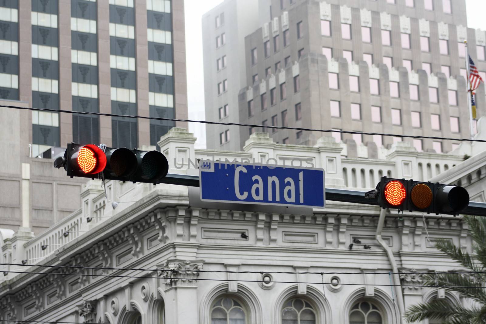 Canal Street stoplight with buildings in the background