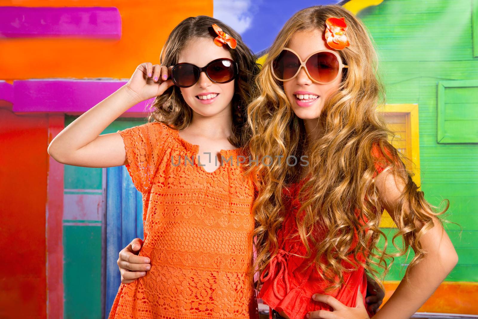 children friends girls in vacation at tropical colorful house by lunamarina
