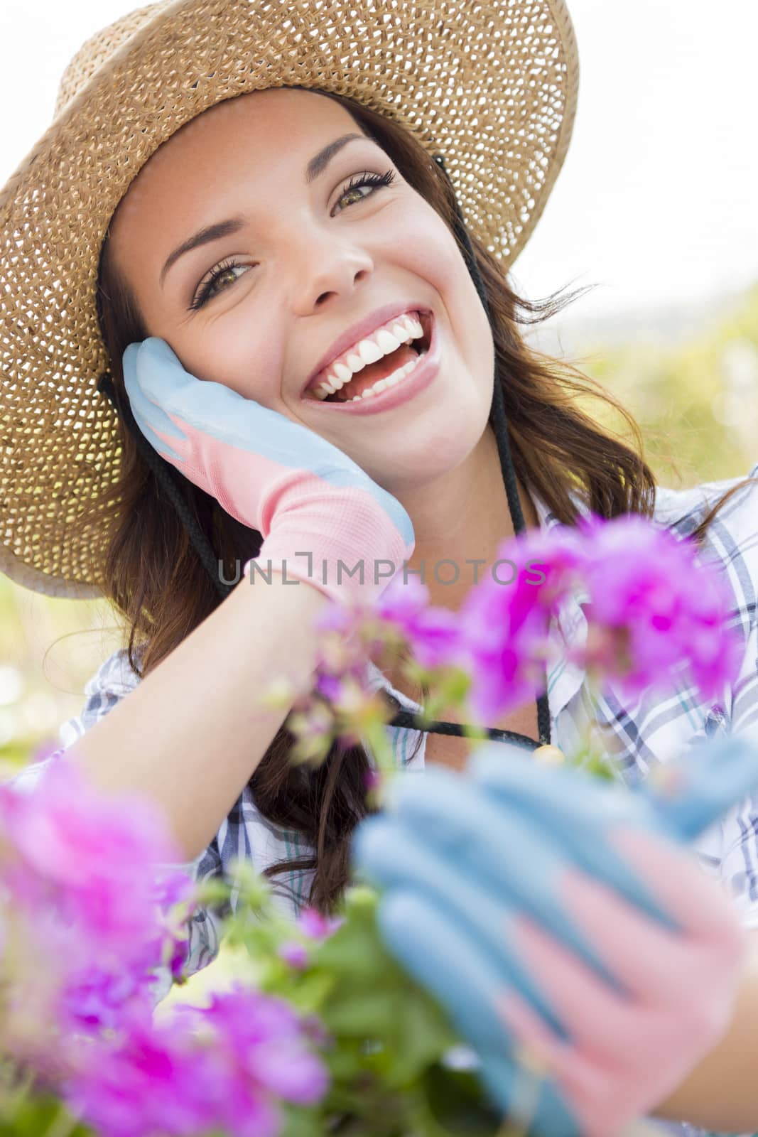 Attractive Happy Young Adult Woman Wearing Hat Gardening Outdoors.