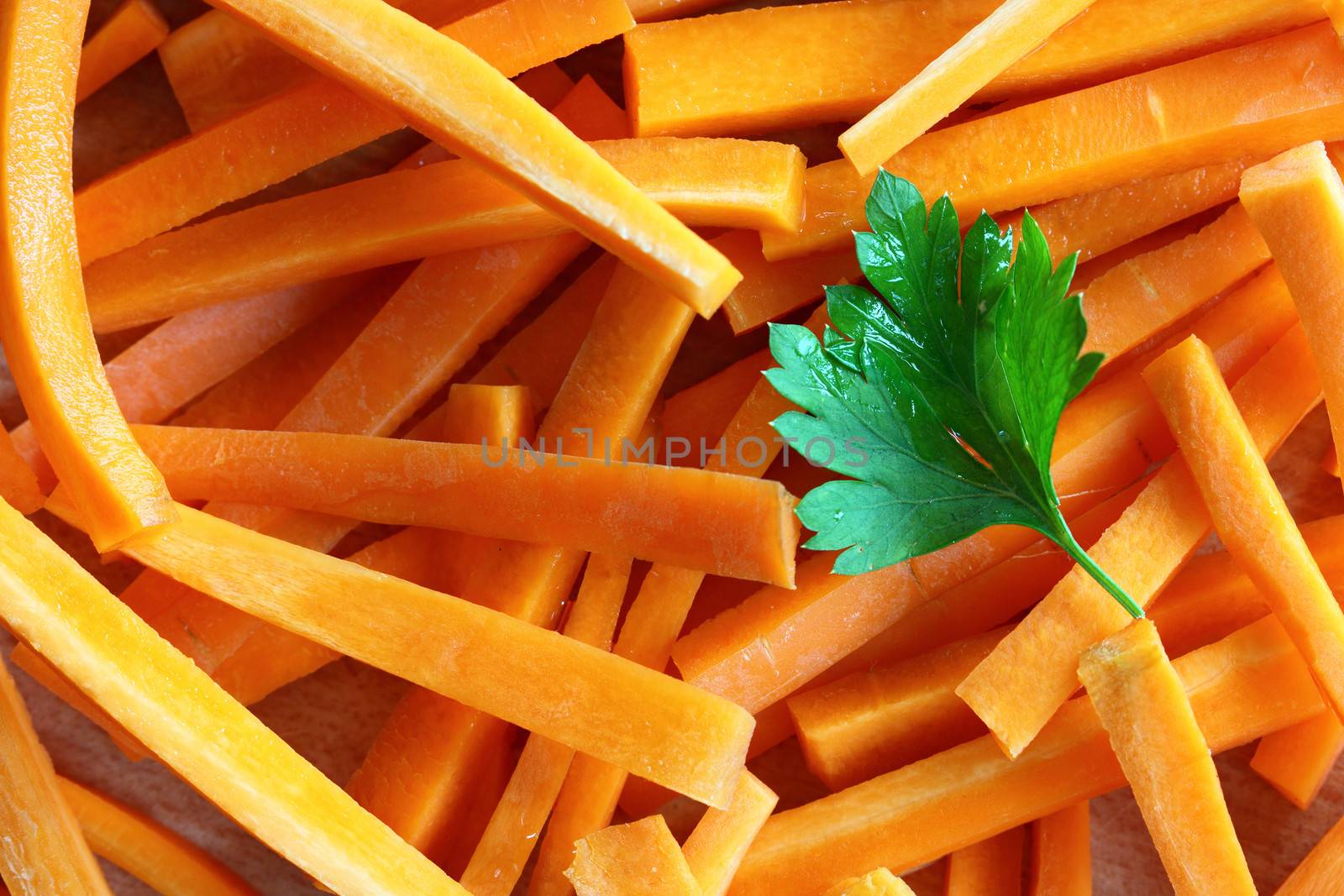 carrots cut into sticks and leaf of parsley