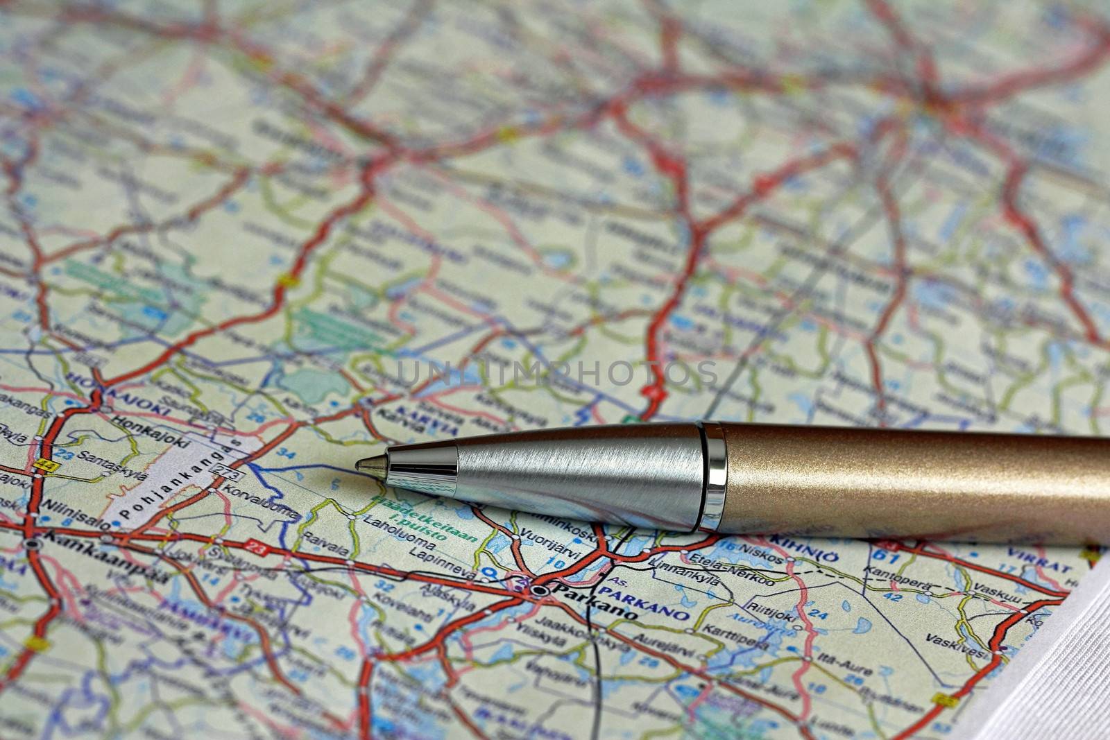 Ballpoint pen over road map of Finland. Shallow depth of field.