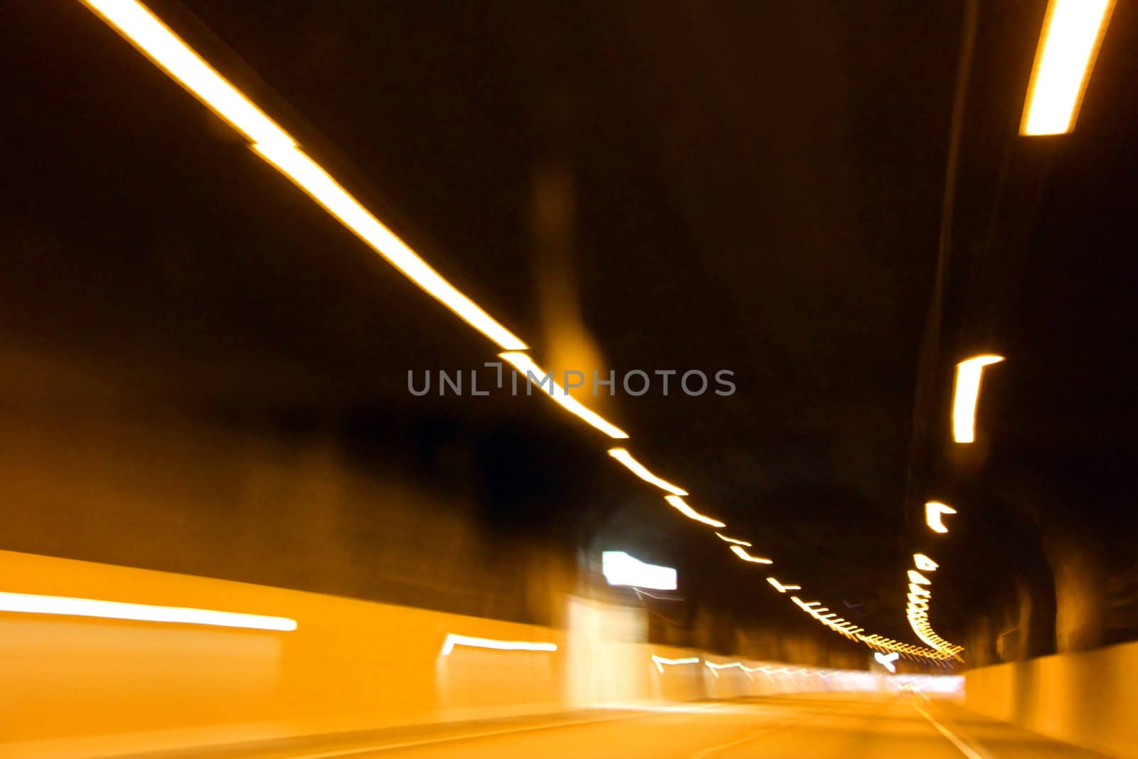 Lights inside an empty highway tunnel.