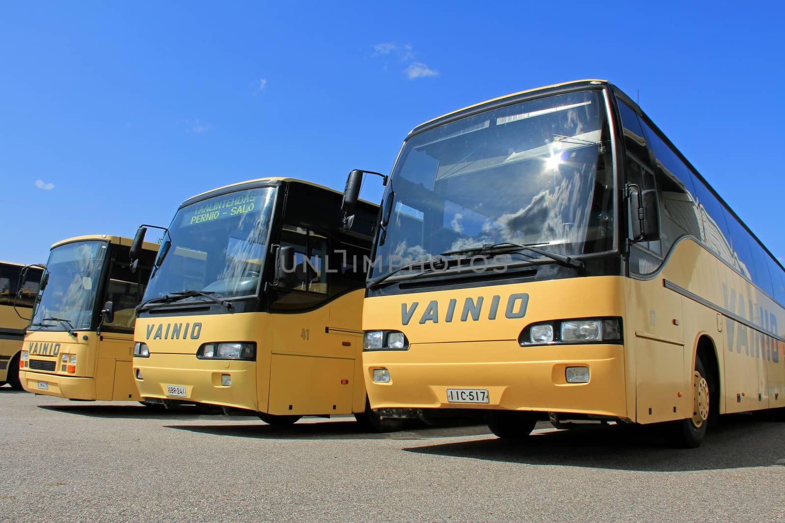 SALO, FINLAND - JULY 14, 2013: A row of Vainion Liikenne buses parked in Salo, Finland on July 14, 2013. Matti Vainio, CEO of Vainion Liikenne, continues the Chairman of Finnish Bus and Coach Association in 2013.