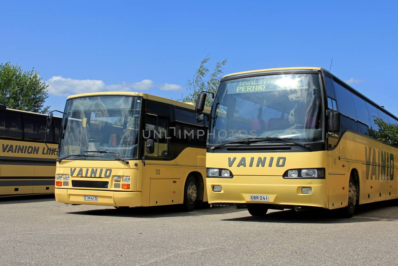SALO, FINLAND - JULY 14, 2013: A row of Vainion Liikenne buses parked in Salo, Finland on July 14, 2013. Matti Vainio, CEO of Vainion Liikenne, continues the Chairman of Finnish Bus and Coach Association in 2013.