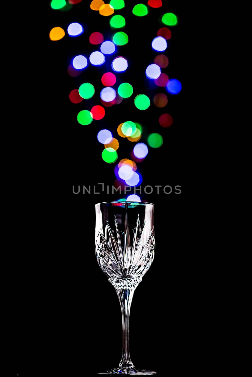 Beautiful light bokeh bubbles coming out of a wine glass