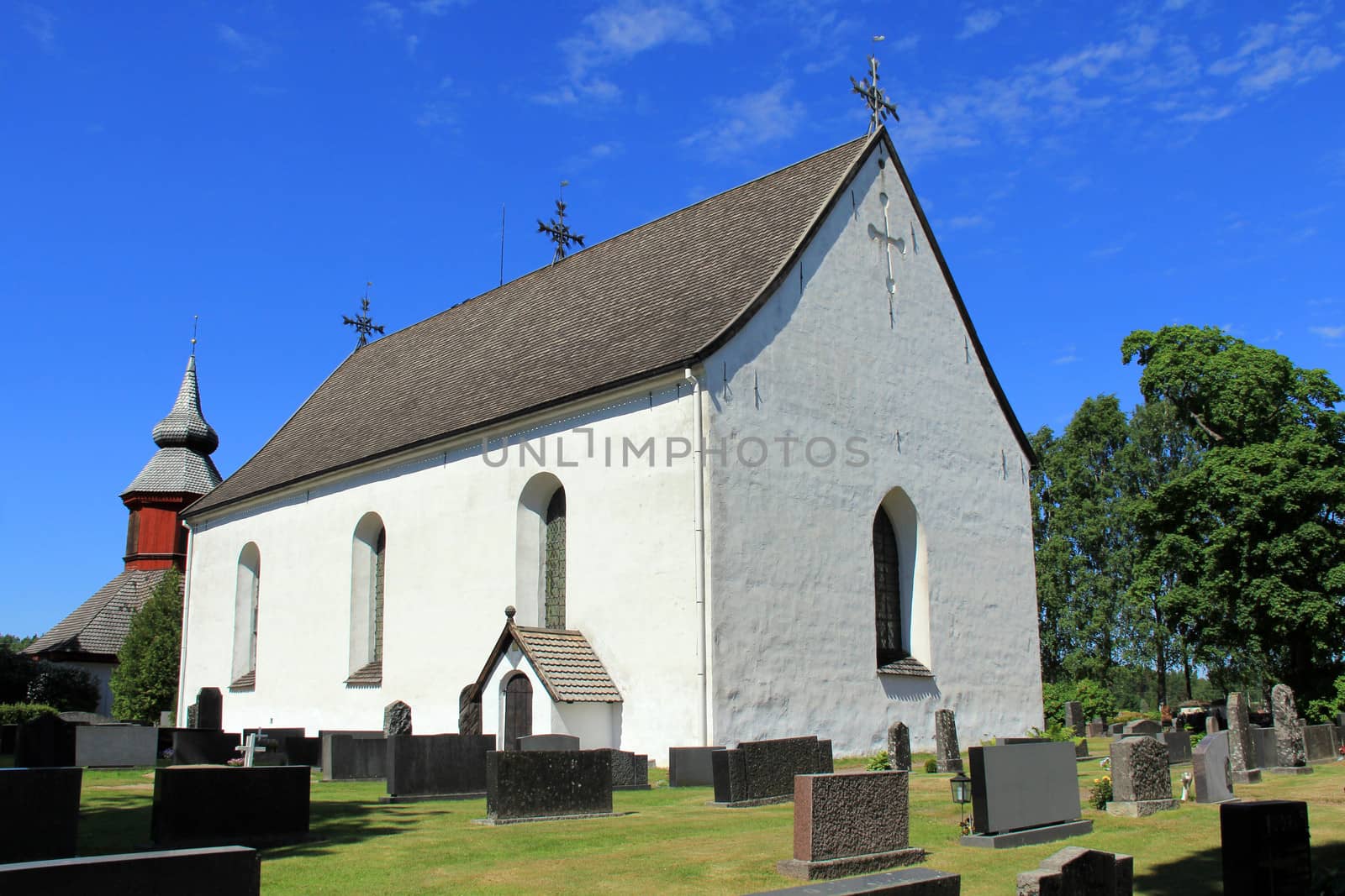 The white Askainen church, Finland, completed 1653, on a bright day of summer.