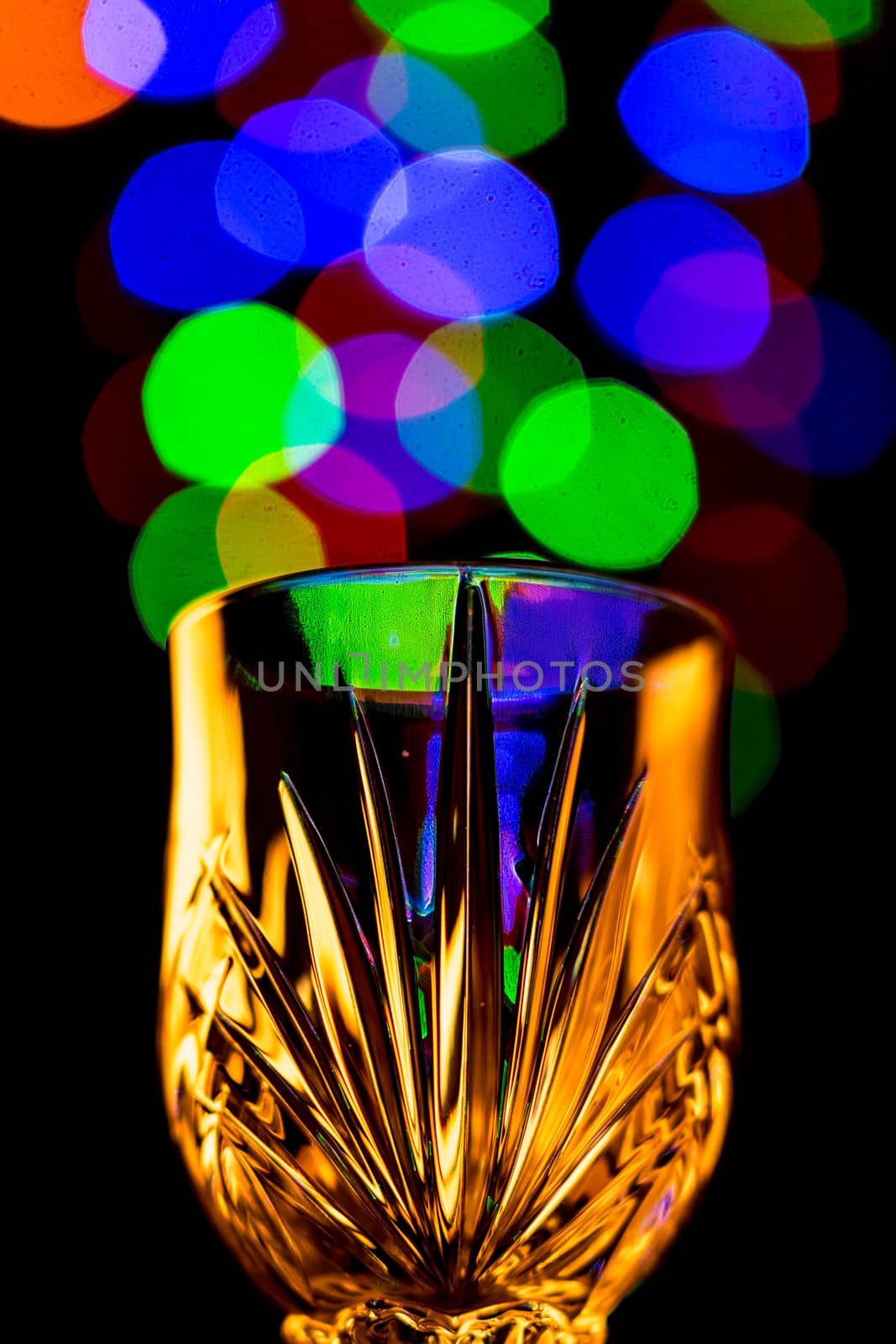 Beautiful light bokeh bubbles coming out of a wine glass