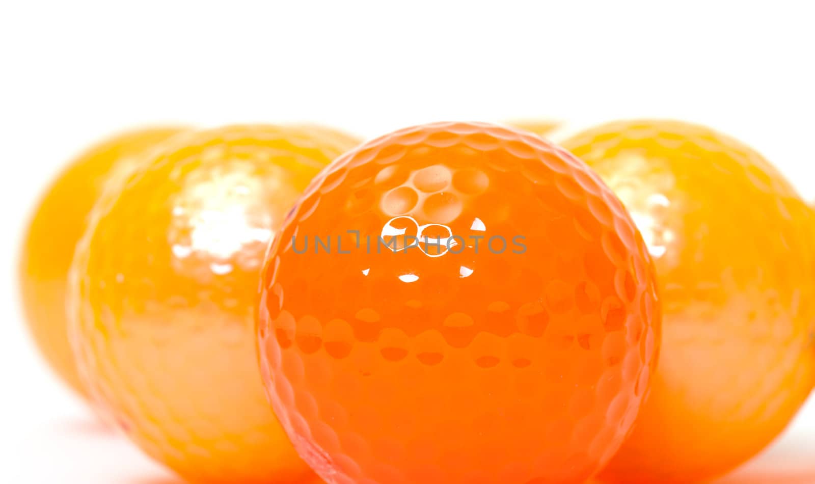 Orange and golden golf balls by Discovod