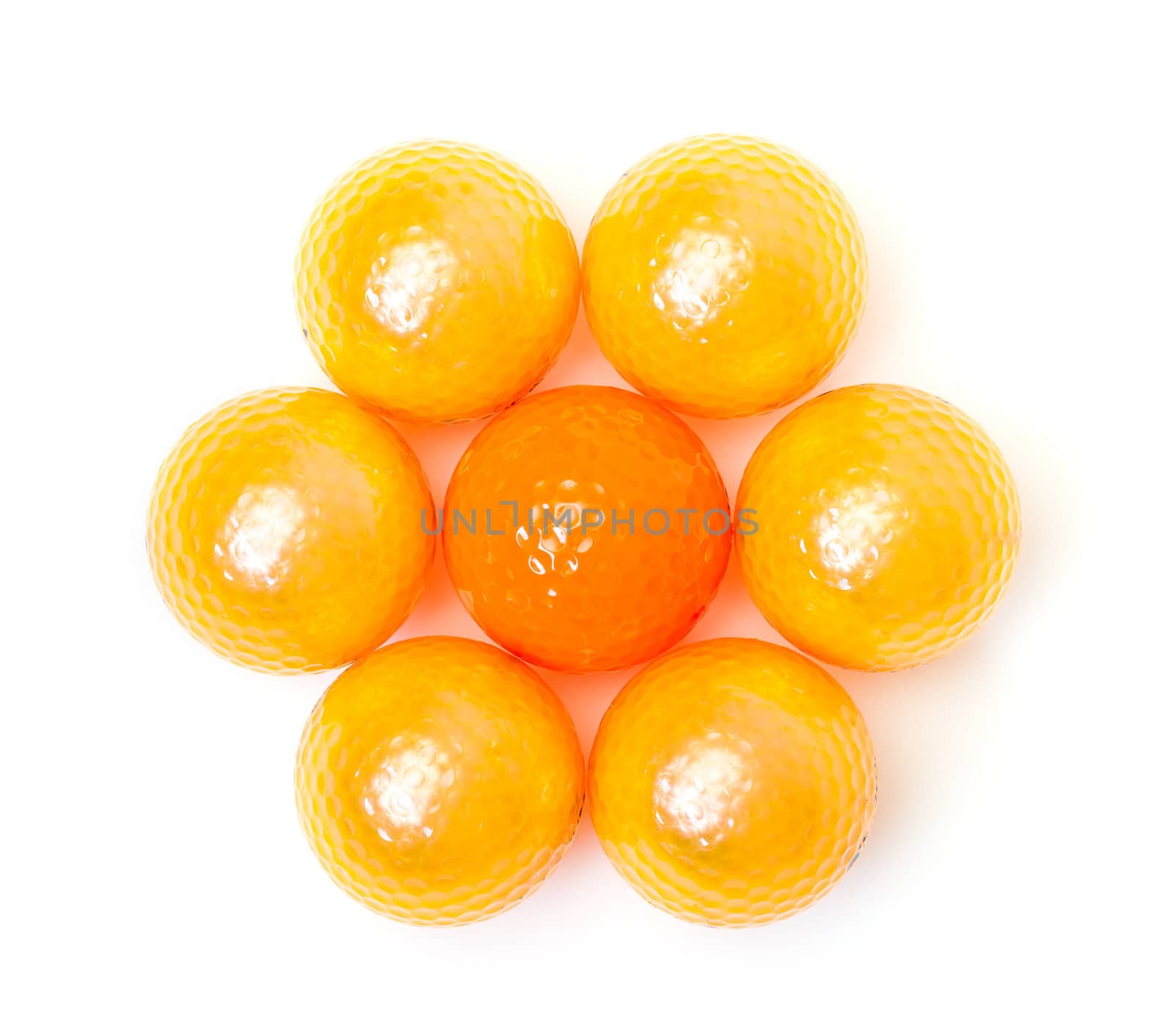 Orange and golden golf balls on white background