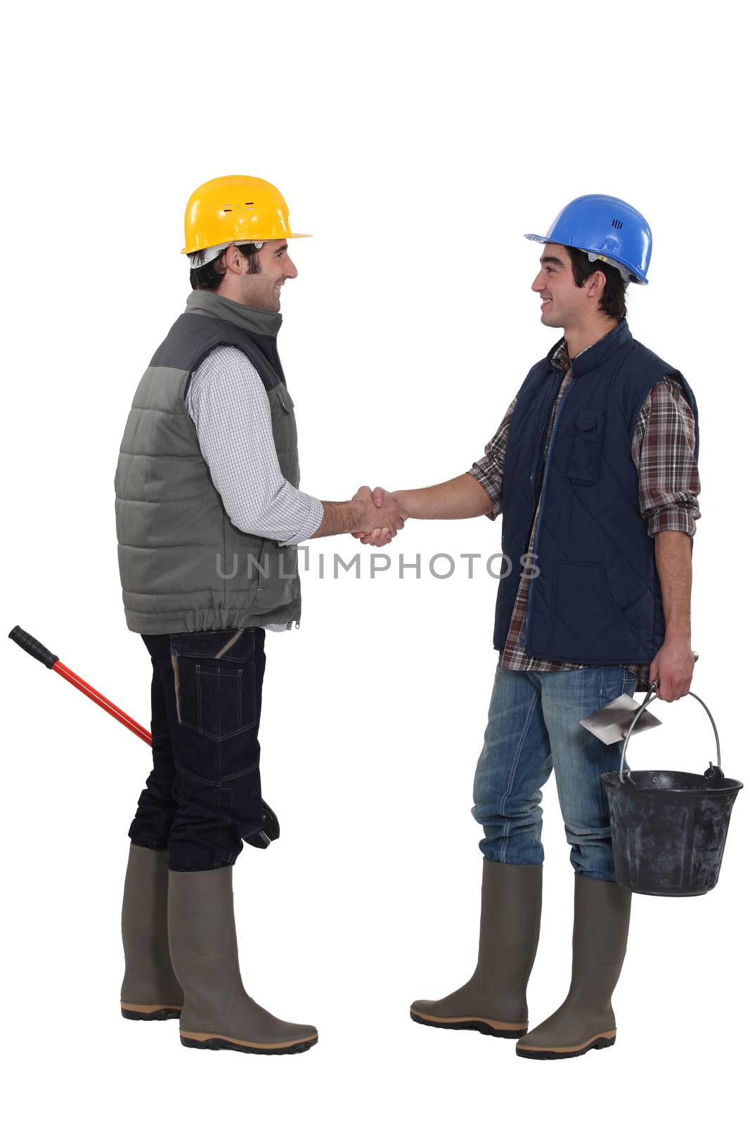 Construction workers shaking hands