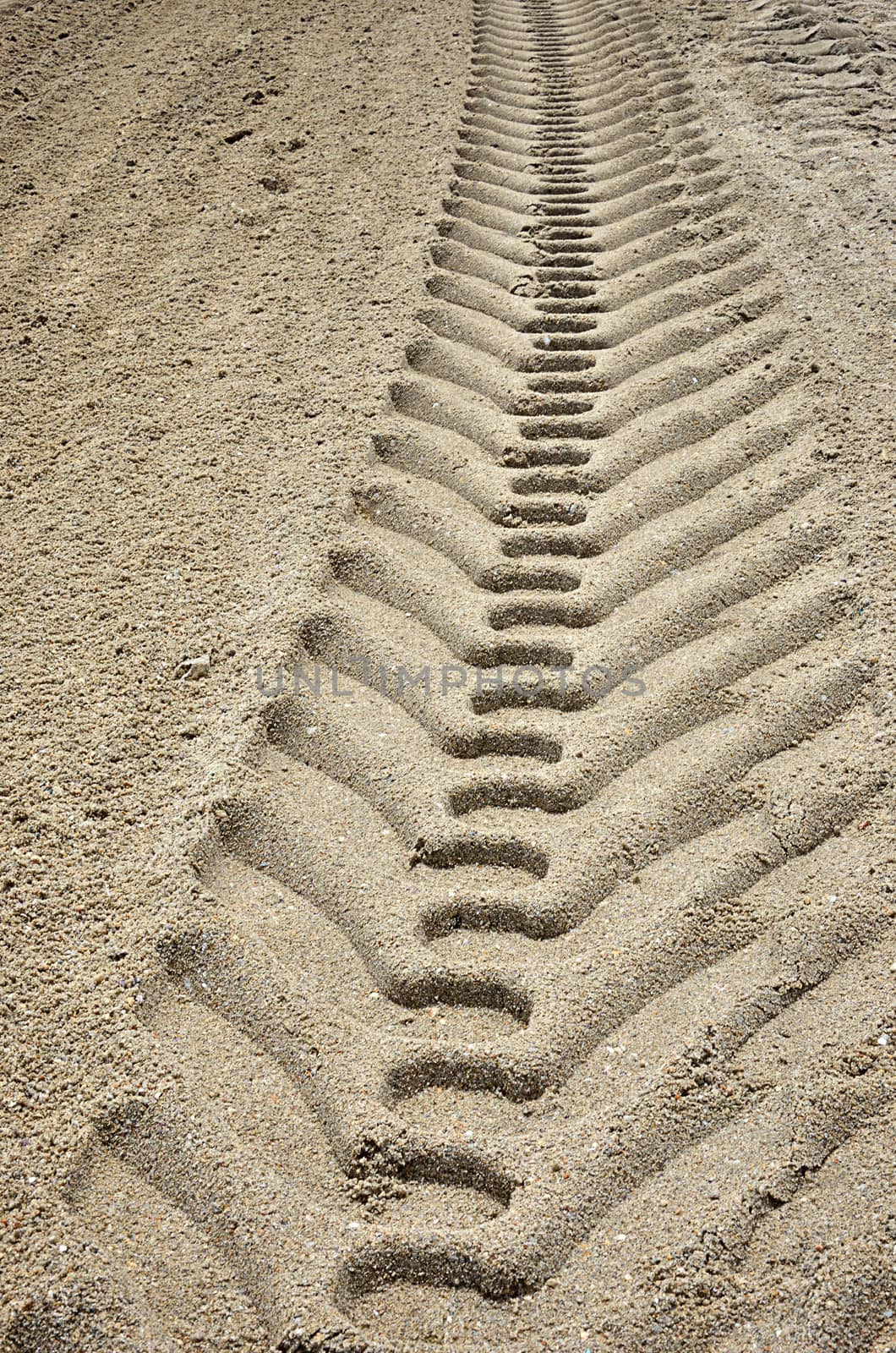 Wheel track on sand background by pixbox77