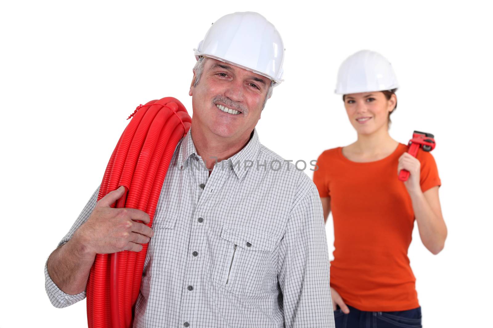 Experienced tradesman with his assistant in the background