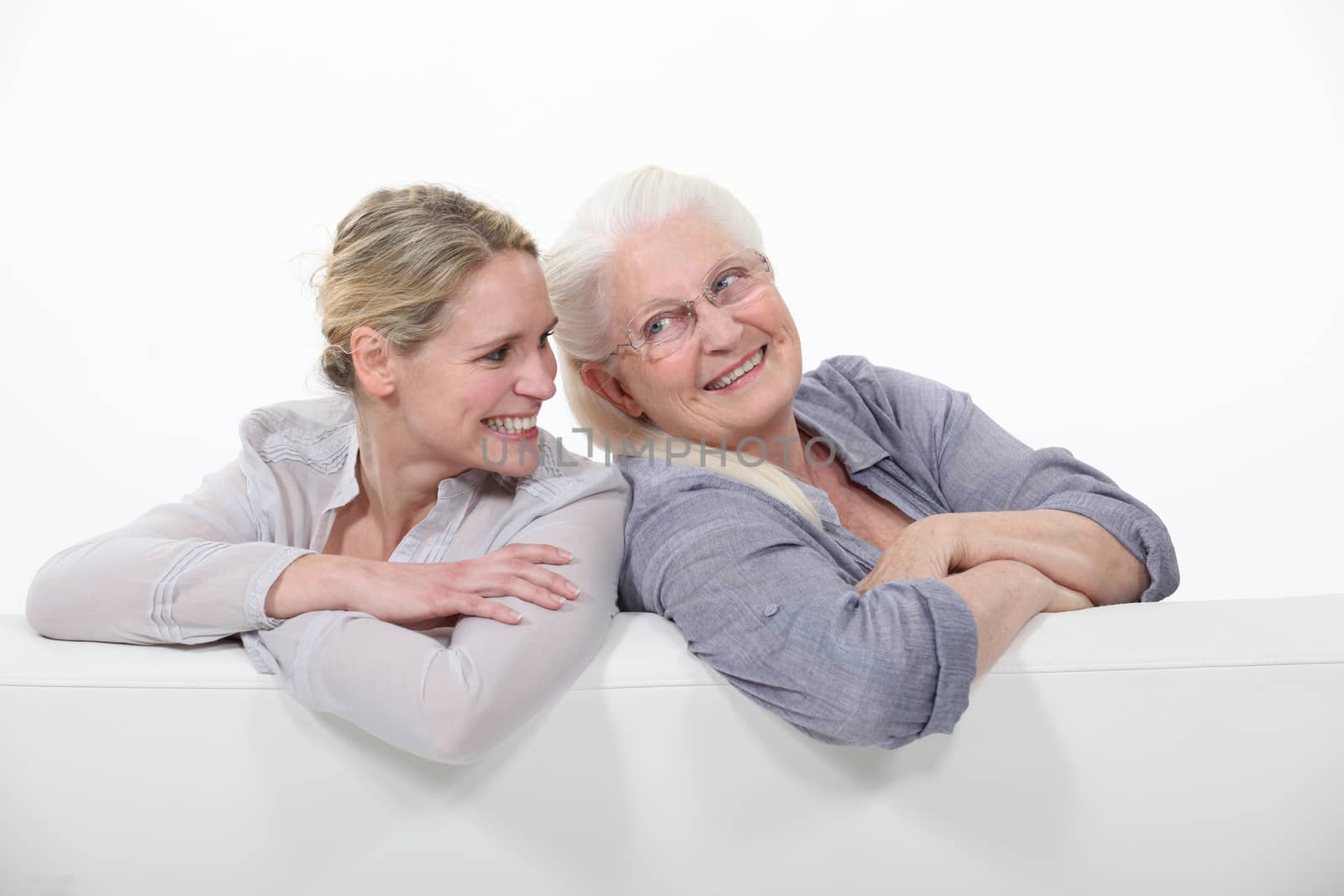 Two women on a white sofa