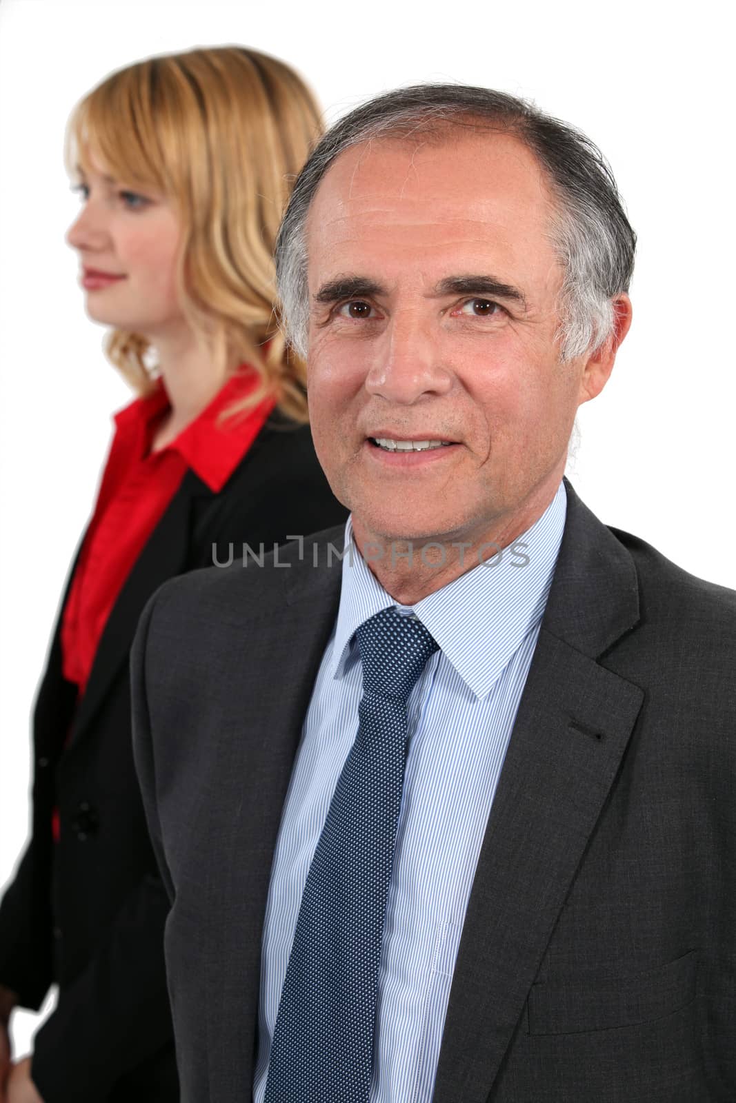 senior businessman and his young assistant posing by phovoir