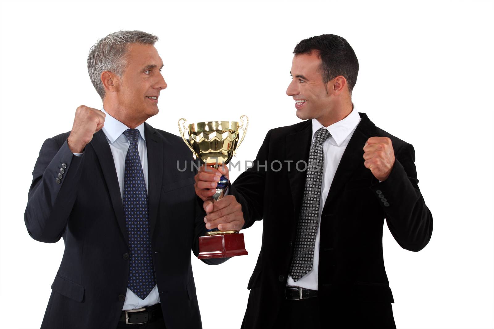 Successful businessmen holding a gold cup