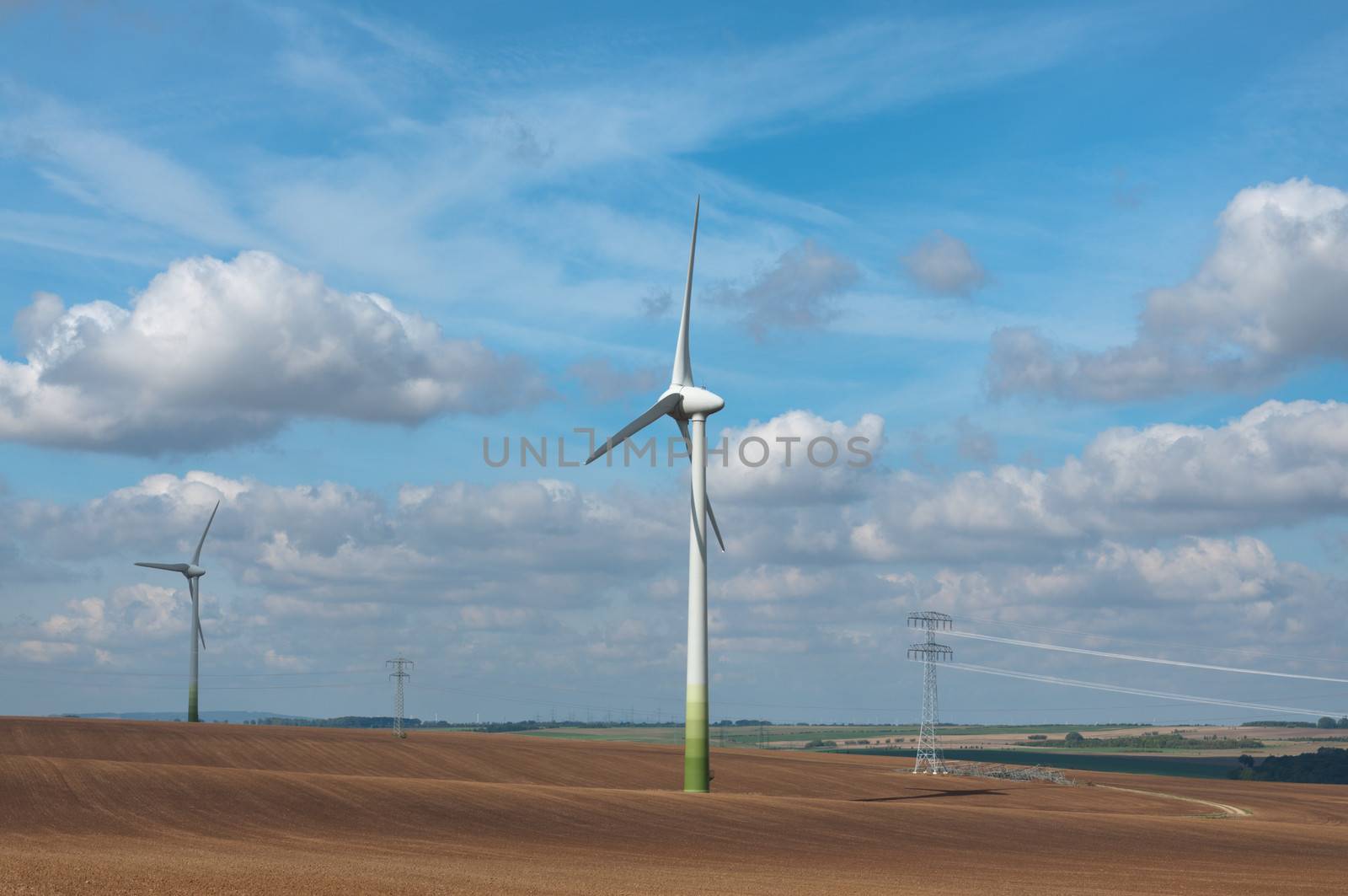 Wind electric generators on field. by BPhoto