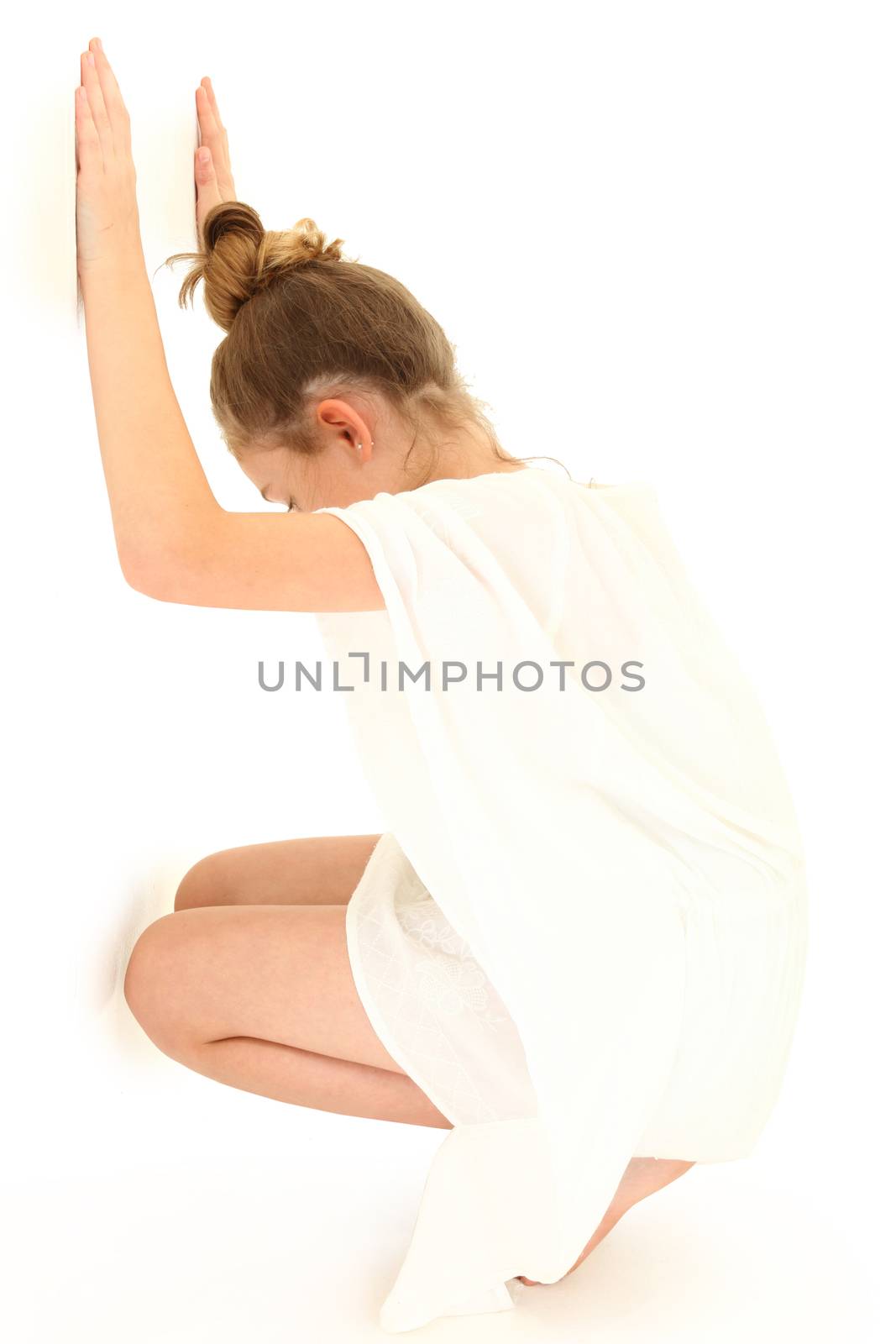 Tween Girl Hiding Against White Wall by duplass