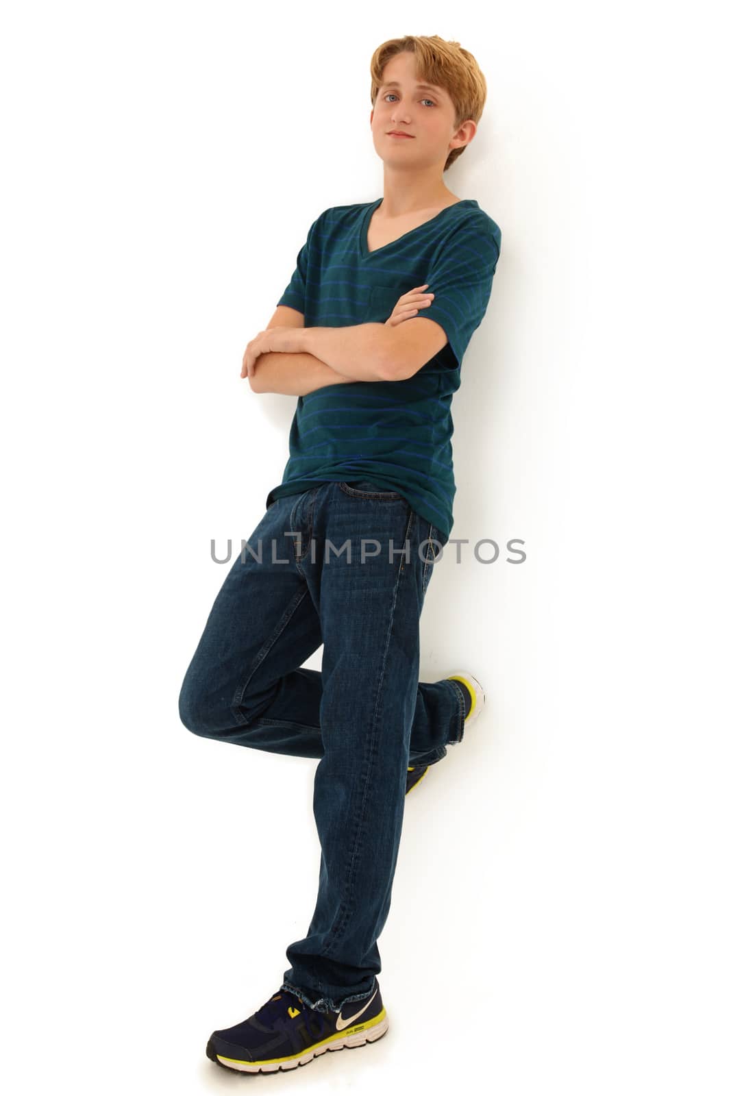 Attractive Teen Boy Leaning Against White Wall
