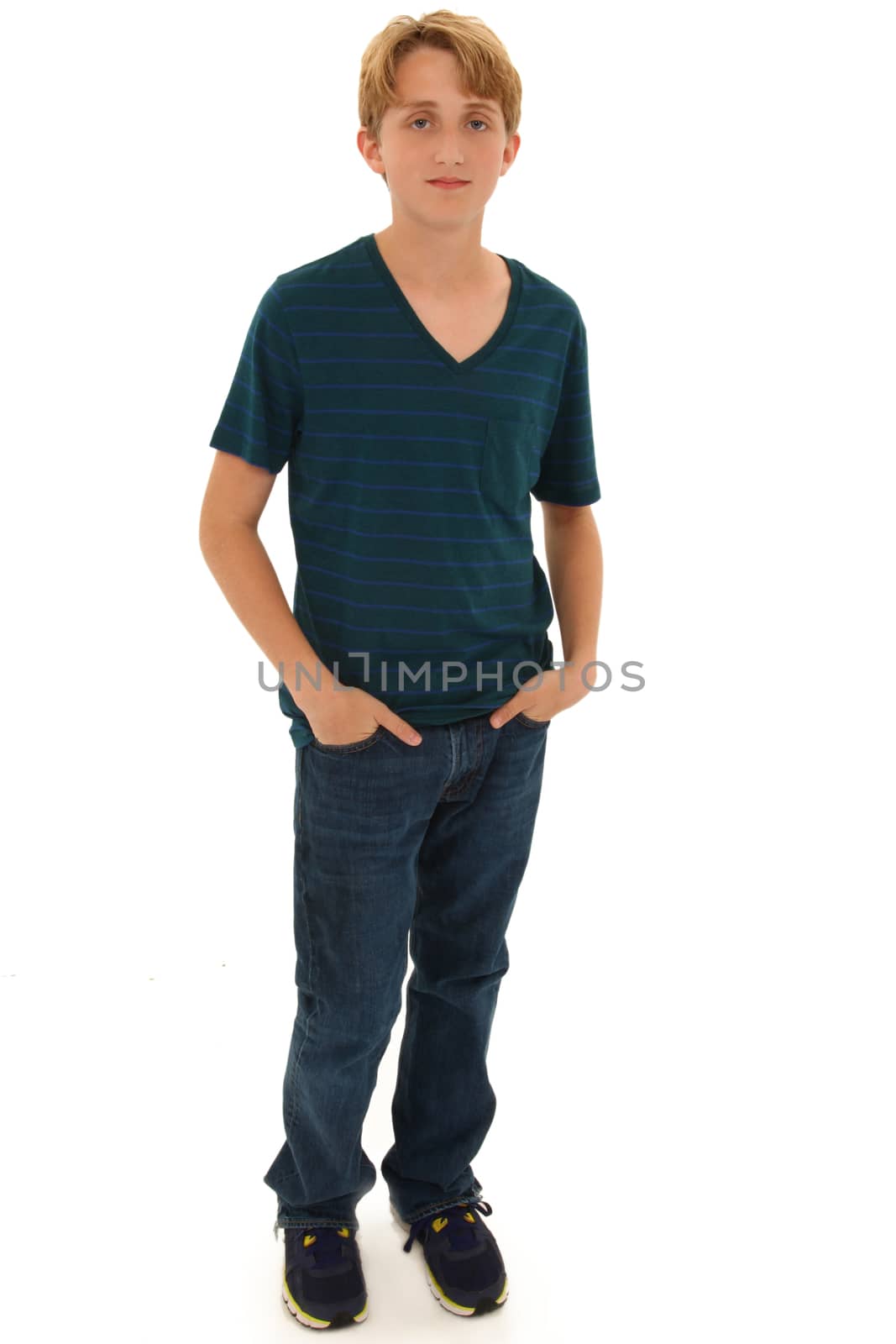 Attractive Teen Boy Caucasian Standing with Hands in Pockets. Serious expression.