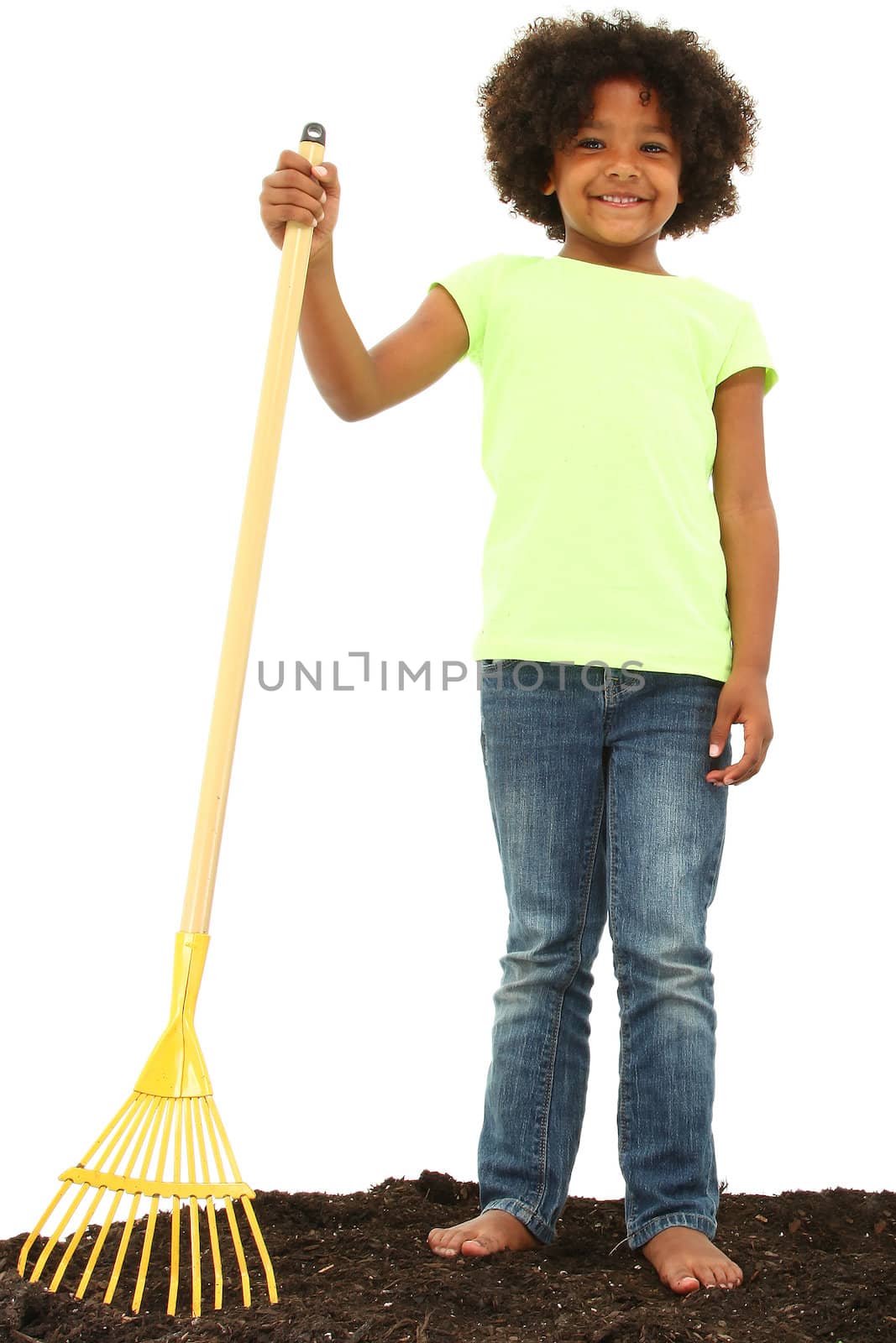 Beautiful Black Girl Child with Rake Standing in Dirt in studio over white.