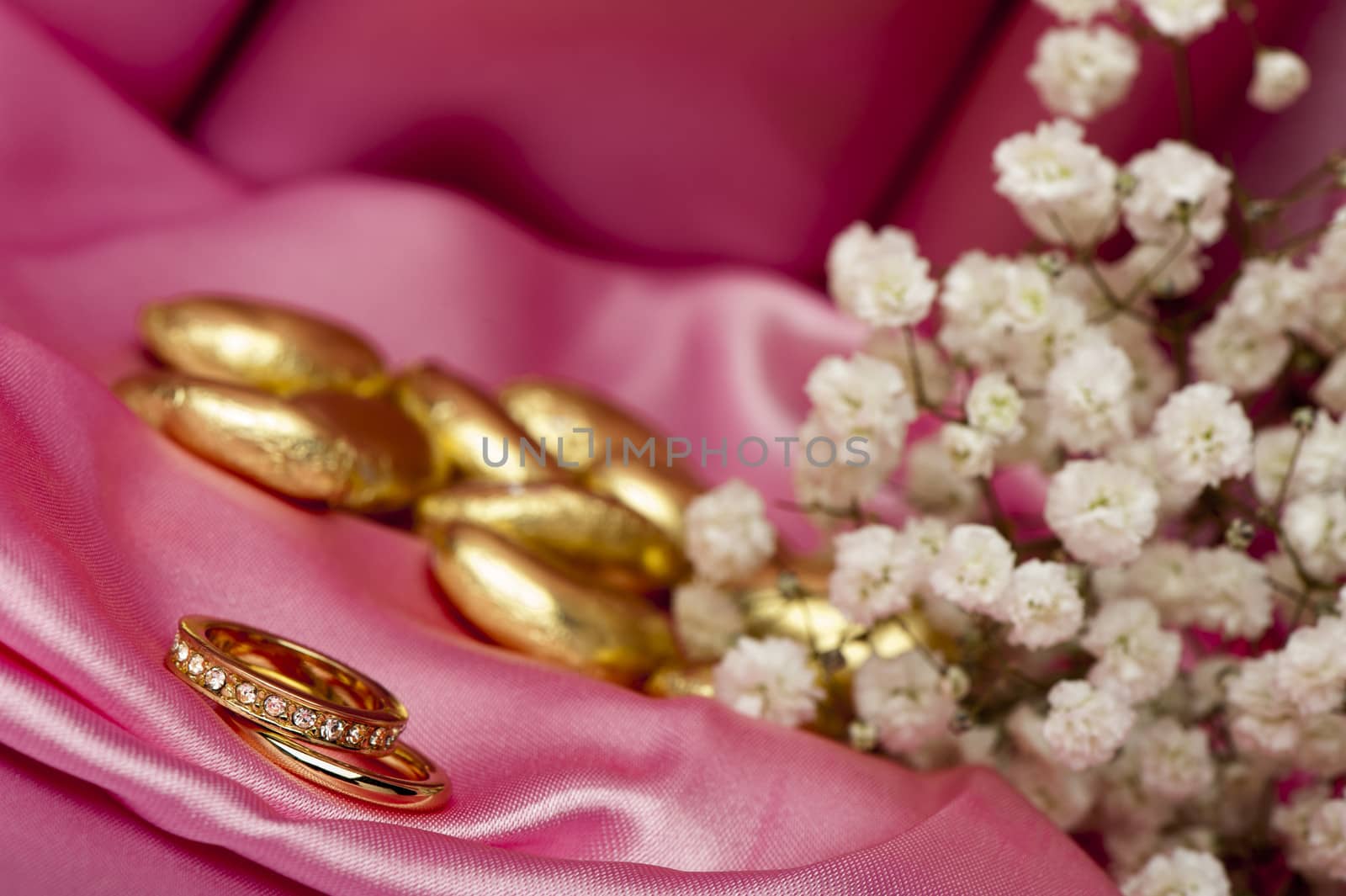  wedding rings on  a colorful fabric background