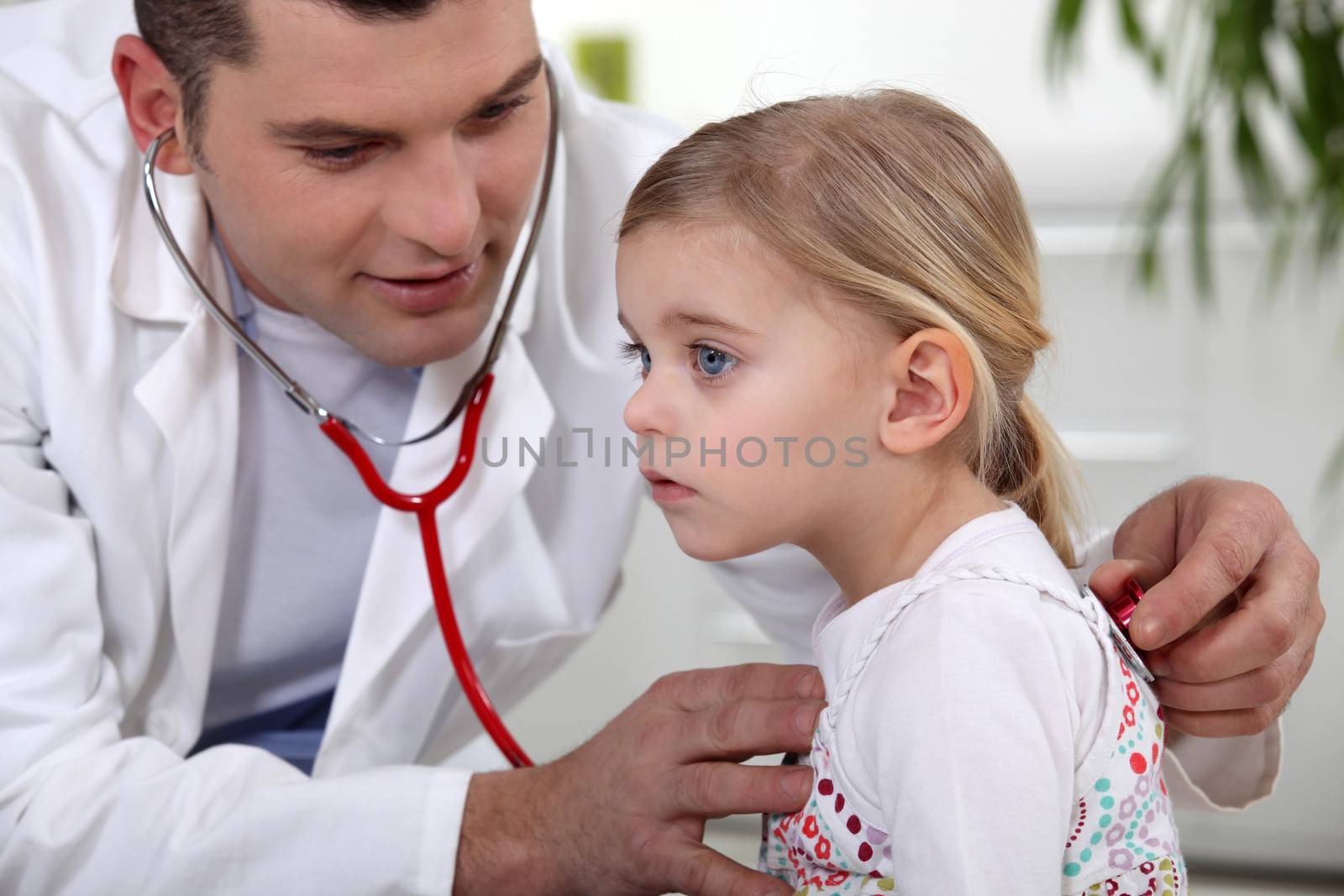 doctor examining little girl