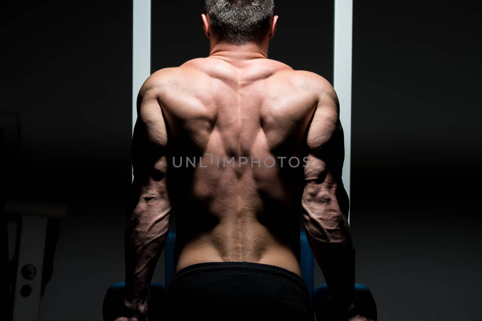 young male bodybuilder doing heavy weight exercise