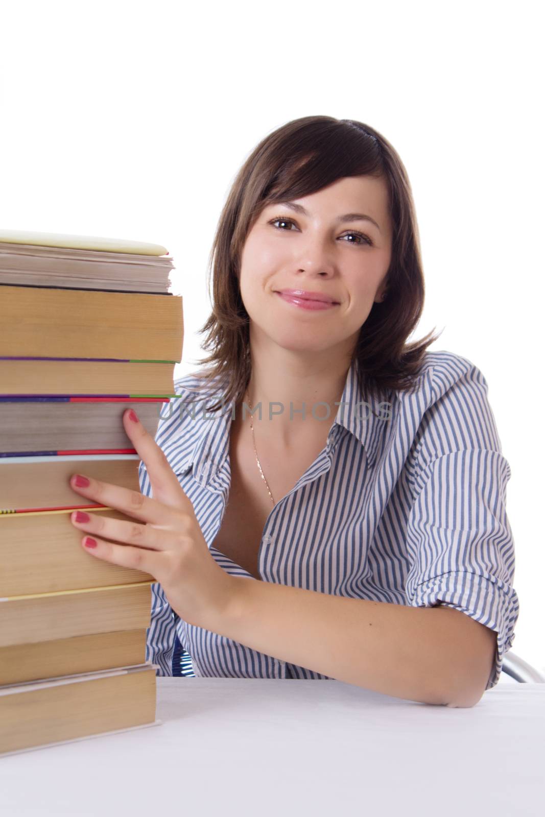 Smiling student girl sitting with pile of books isolated