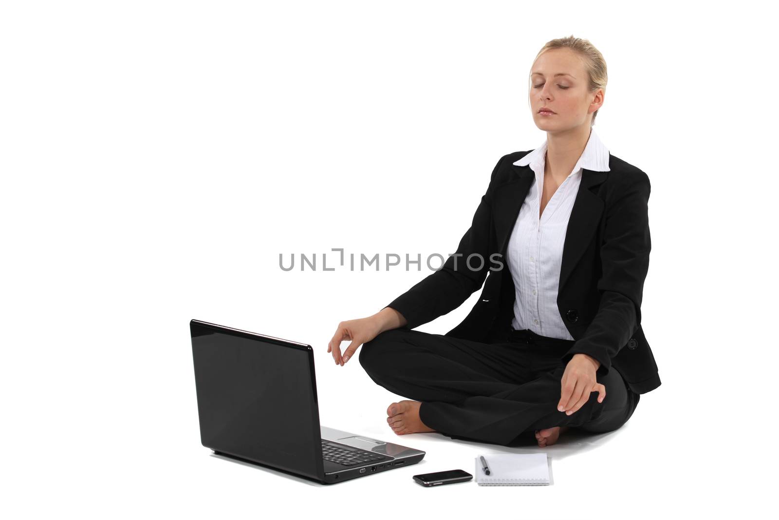 Businesswoman in yoga position by phovoir