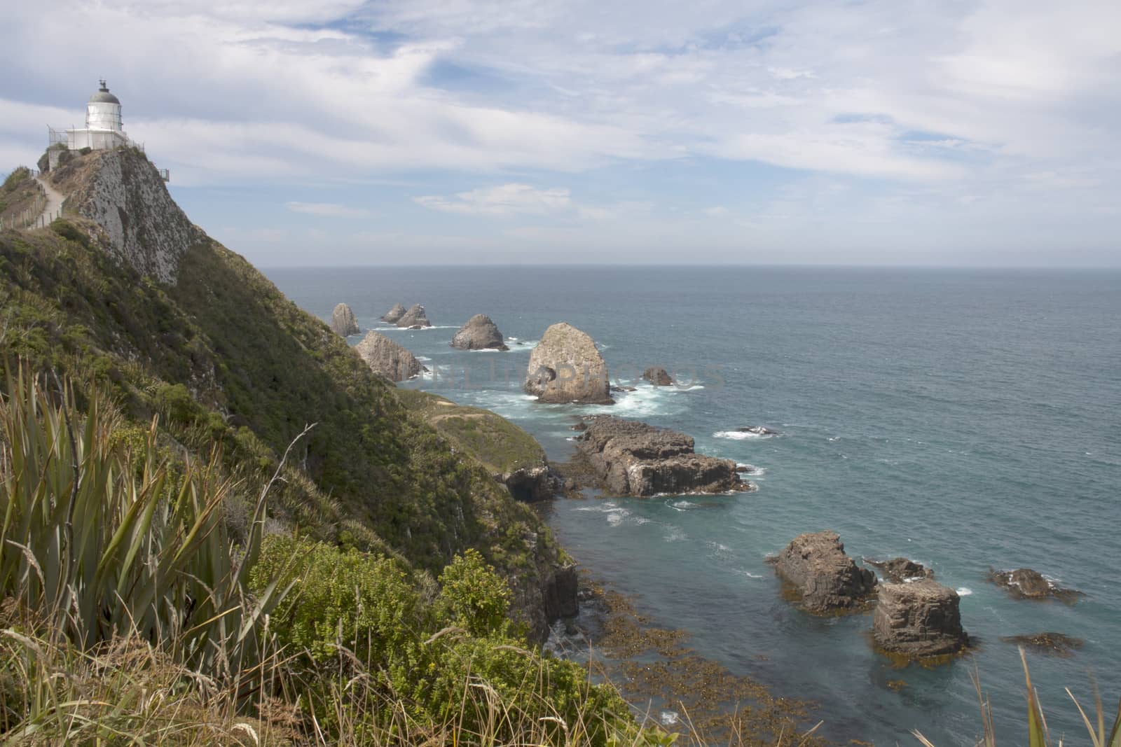 Lighthouse at Nugget Point, Otago, New Zealand overlooking the rocks