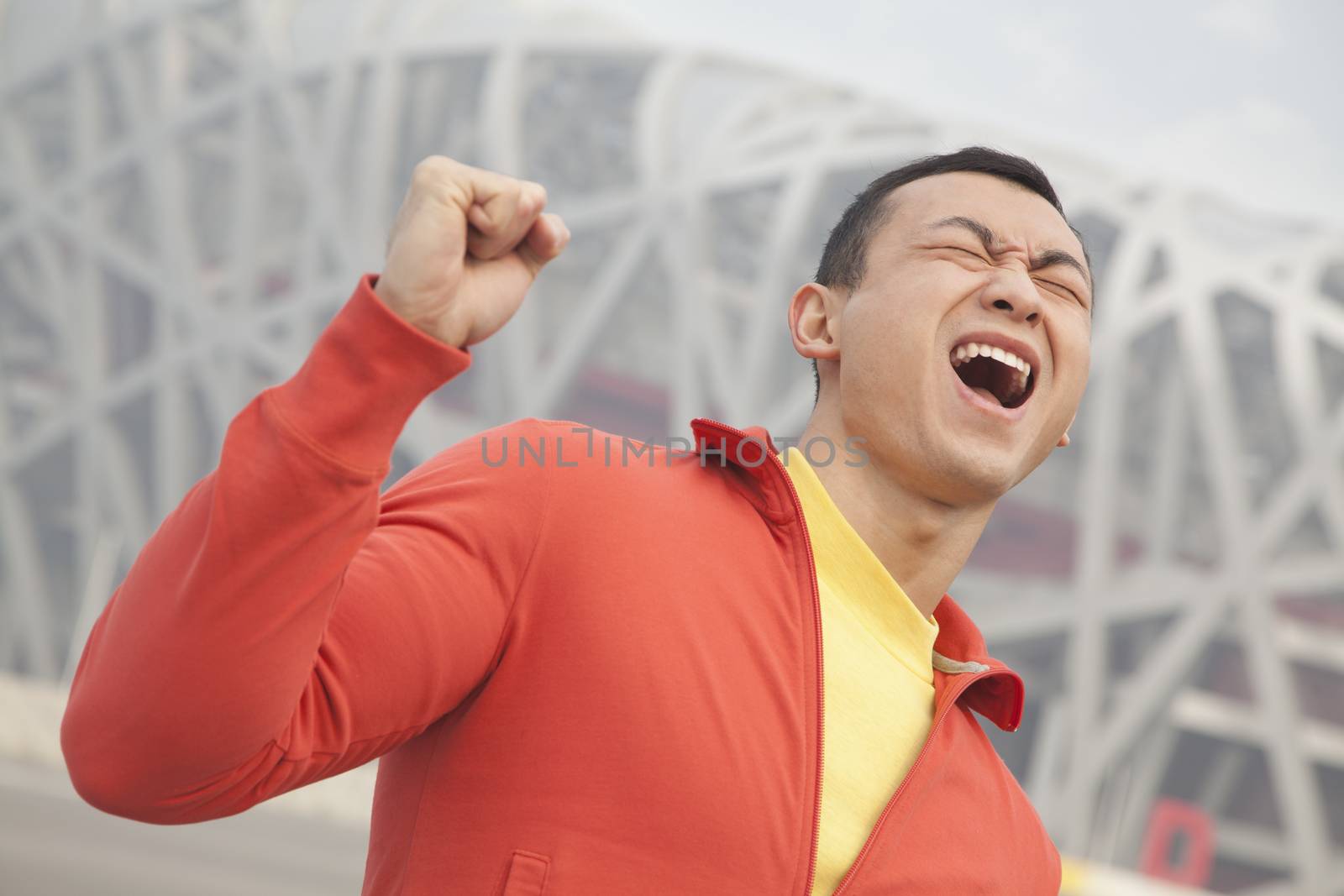 Determined young man with fist in the air, Beijing 