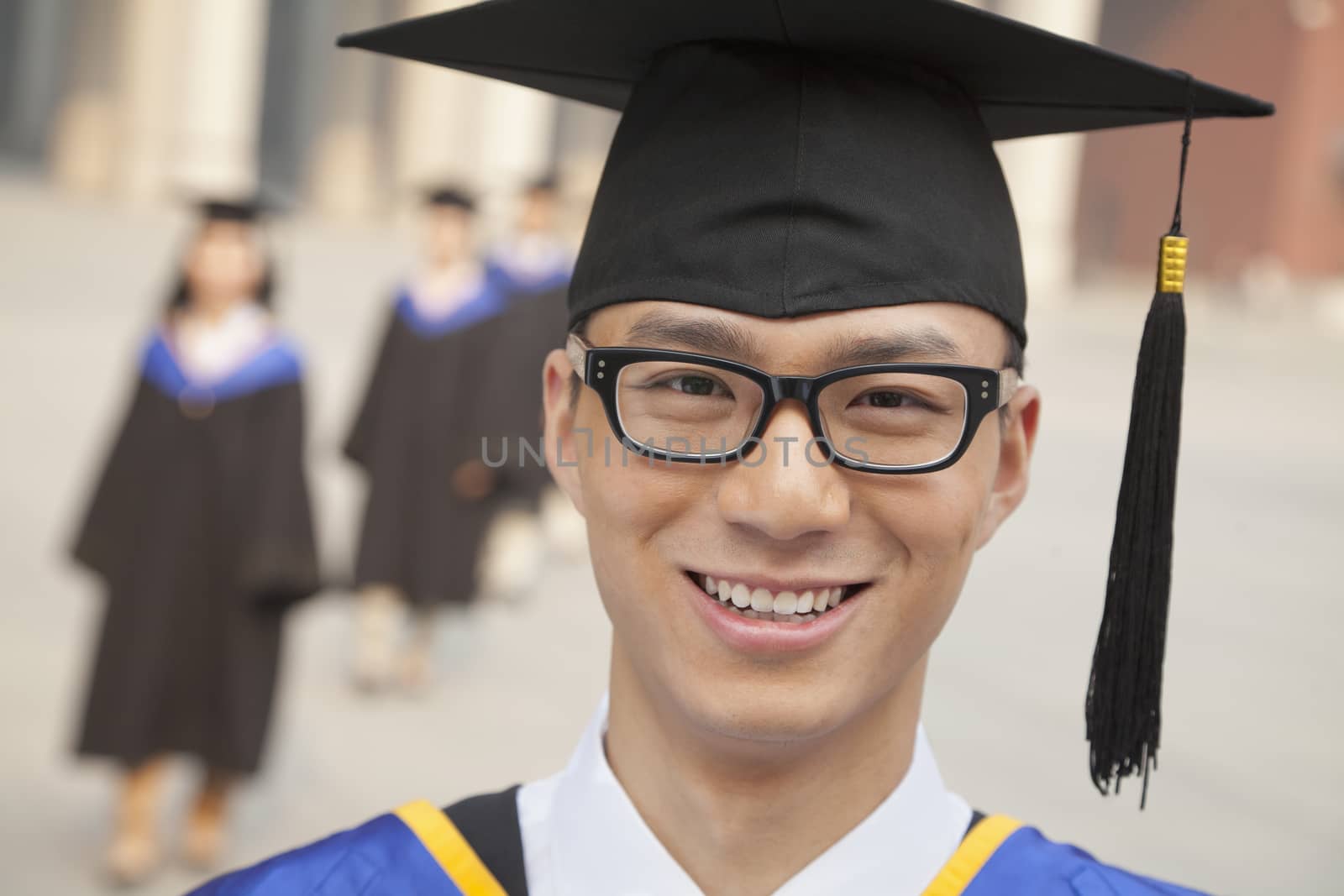 Young Graduate with Glasses Smiling, Portrait Looking at Camera