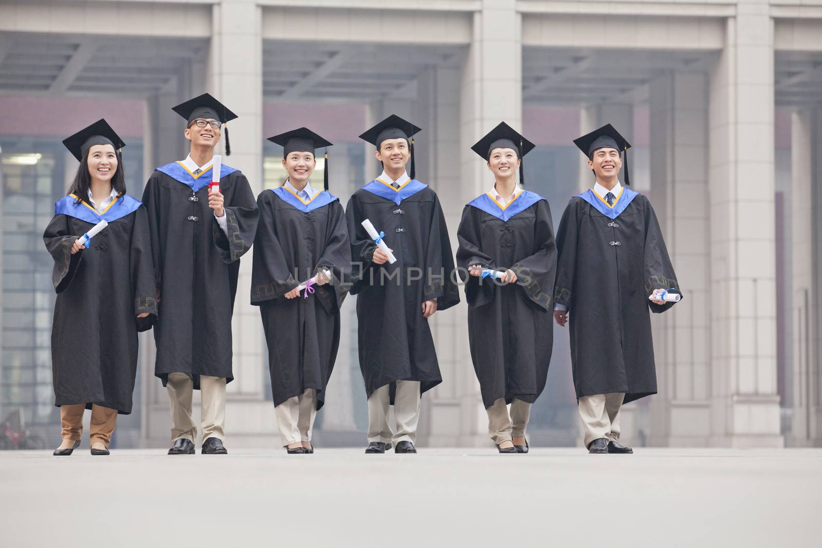 Group of Graduate Students Standing with Diplomas by XiXinXing