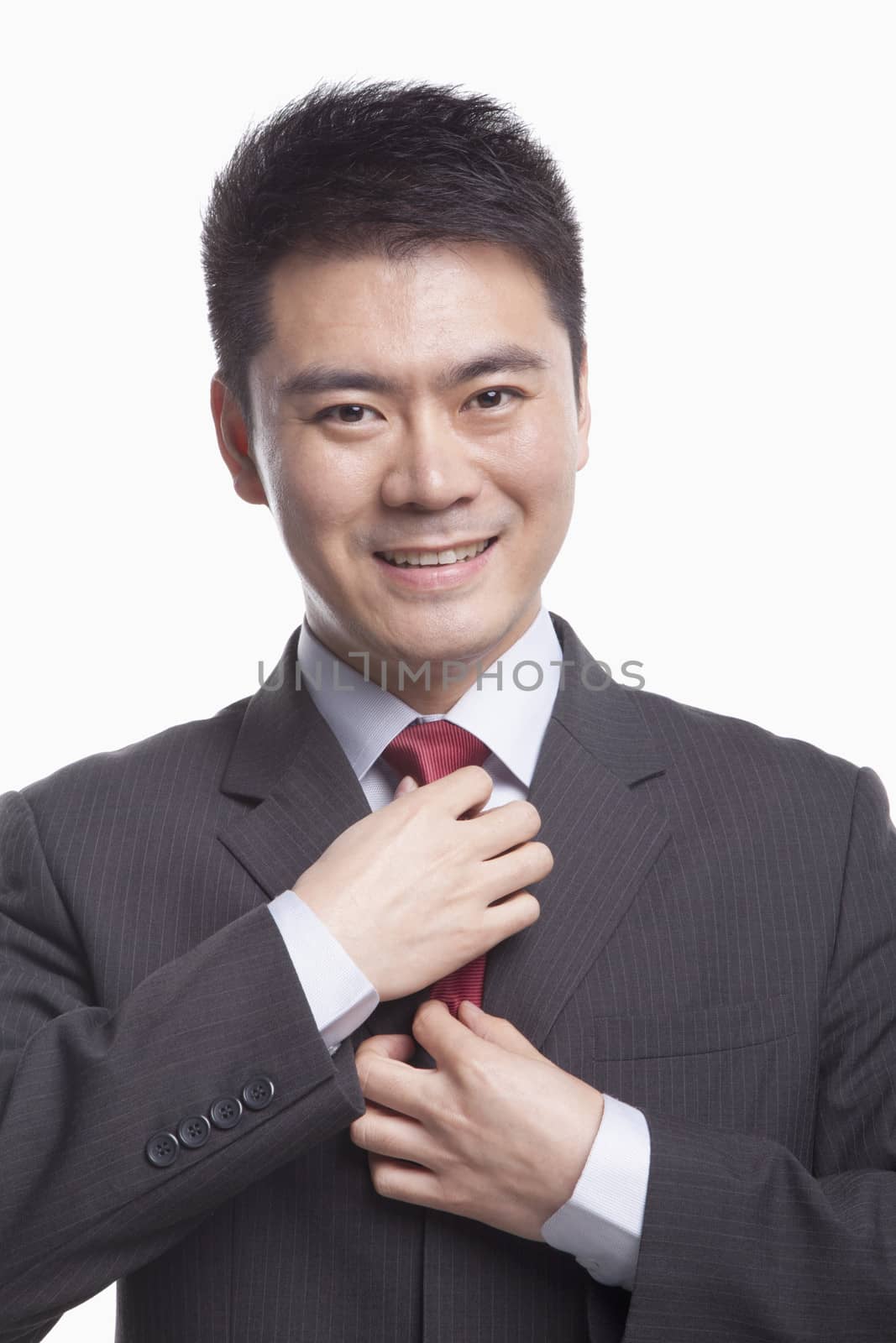 Businessman Adjusting His Tie