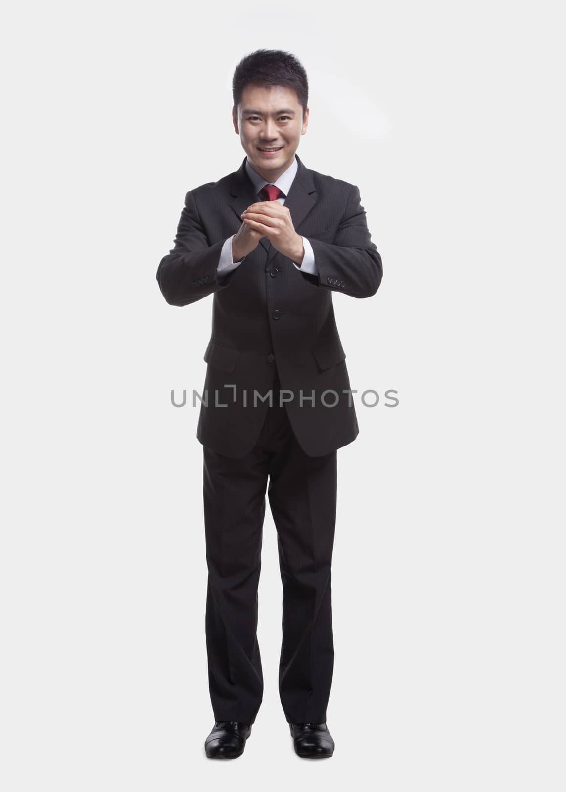 Businessman Bowing Toward Camera