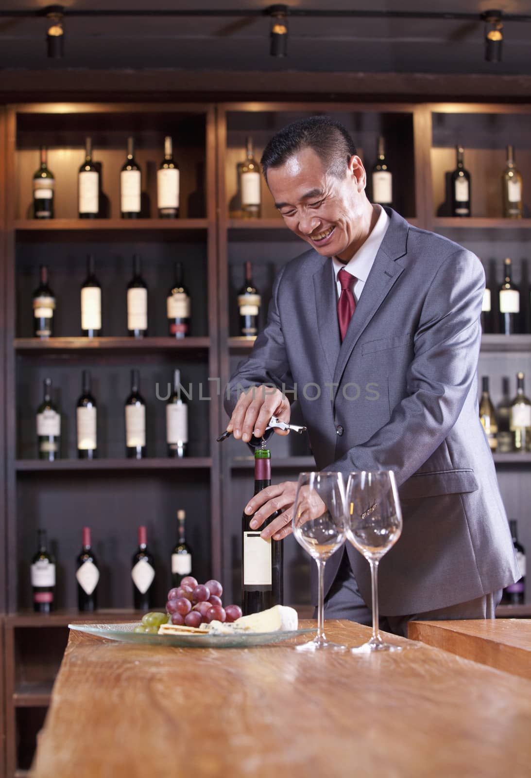 Businessman Opening Wine Bottle 