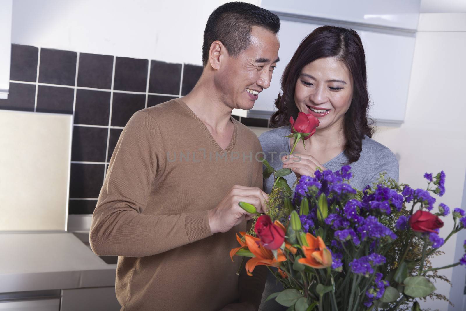 Mature Couple with Bouquet of Flowers, Man Holding a Rose