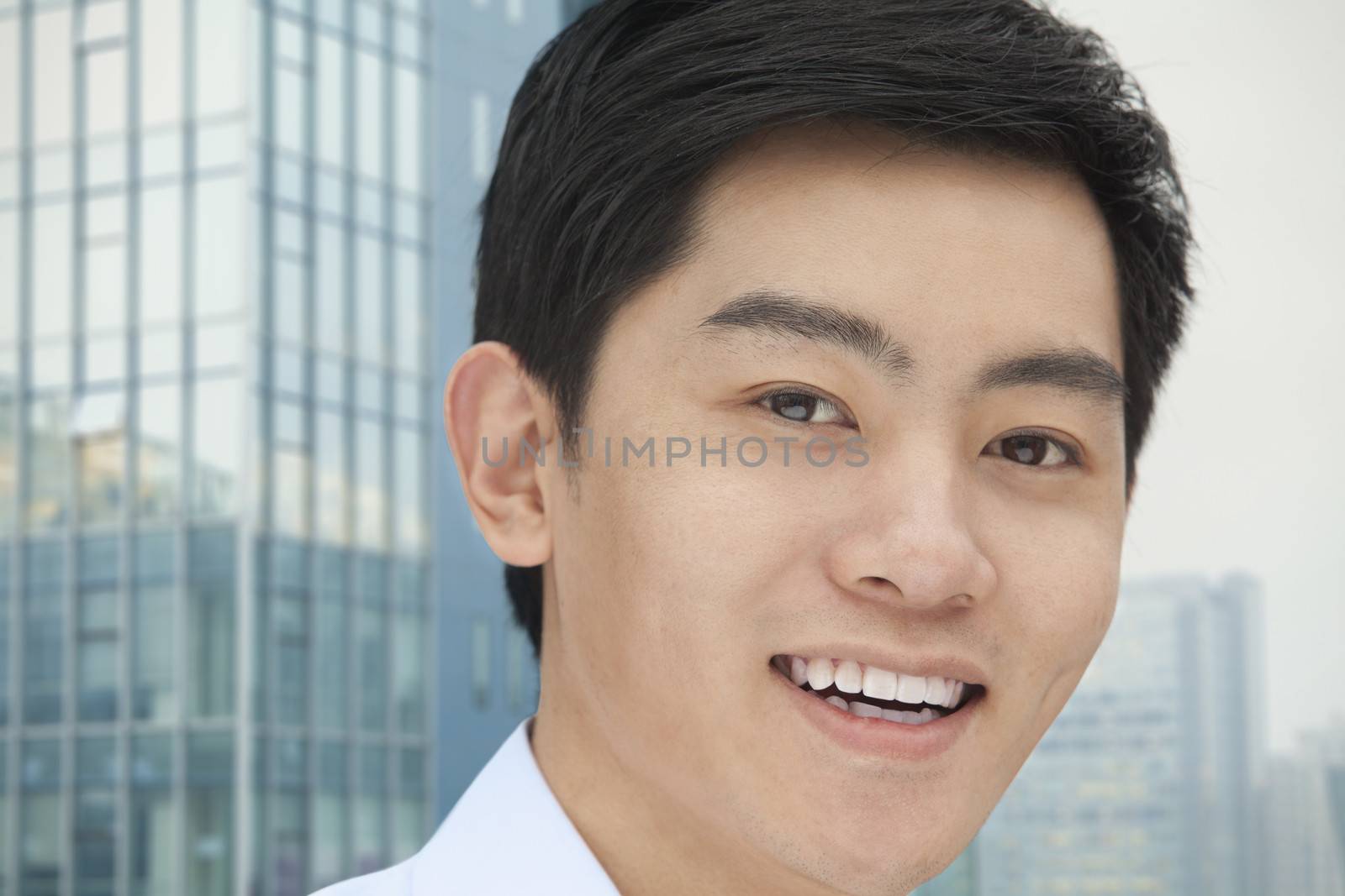 Portrait of young businessman close-up, outdoors, Beijing