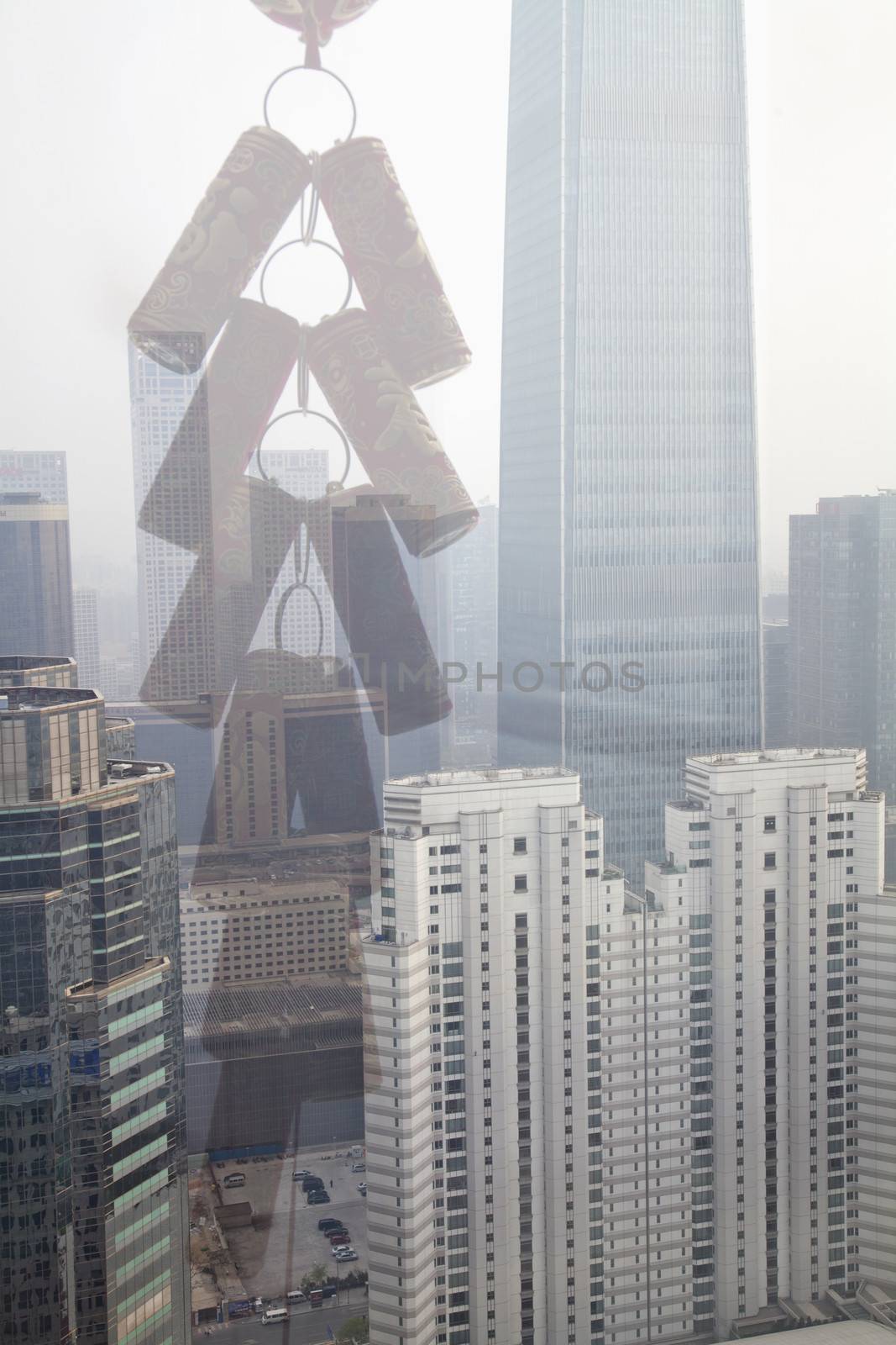 Double exposure of Chinese ornament over cityscape