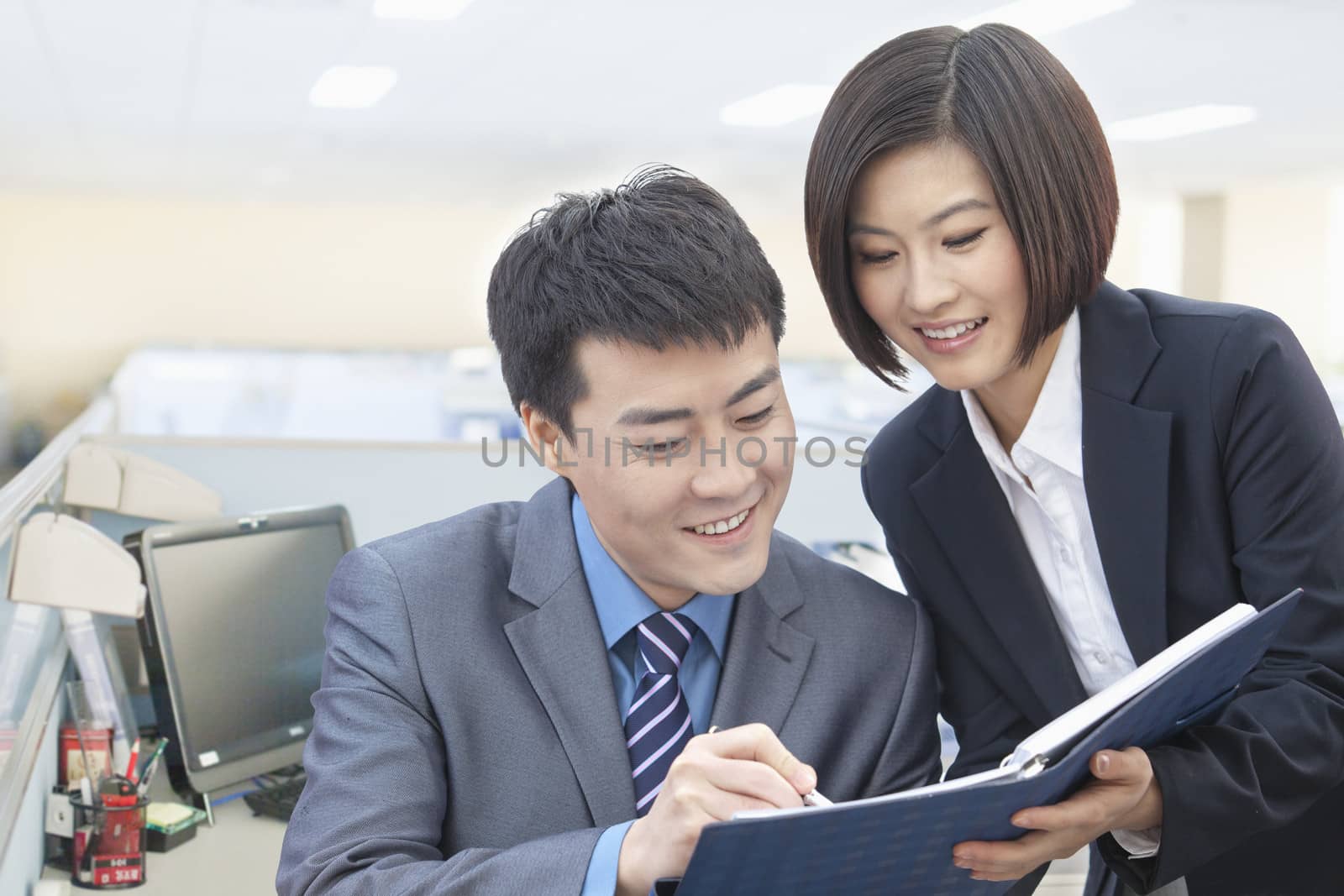 Two Business People Looking at Note Pad