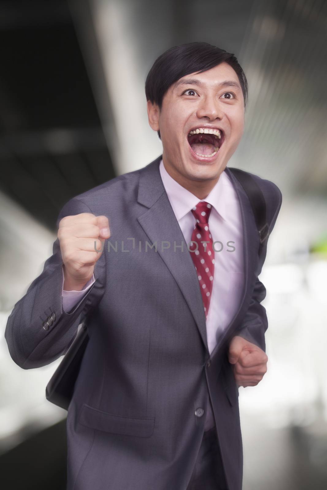 Young businessman running, Beijing