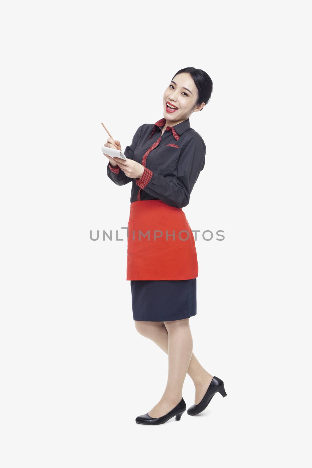 Young waitress taking an order, studio shot