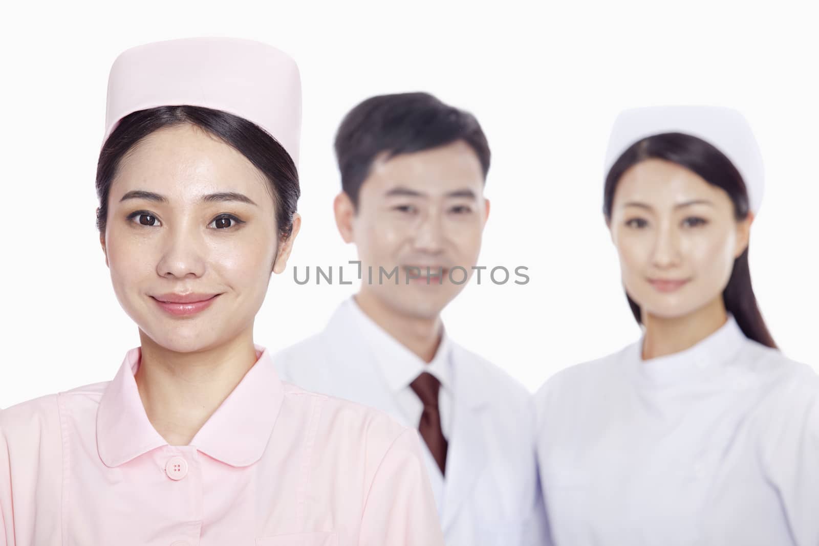 Portrait of young nurse, doctor and nurse in the background, studio shot  by XiXinXing