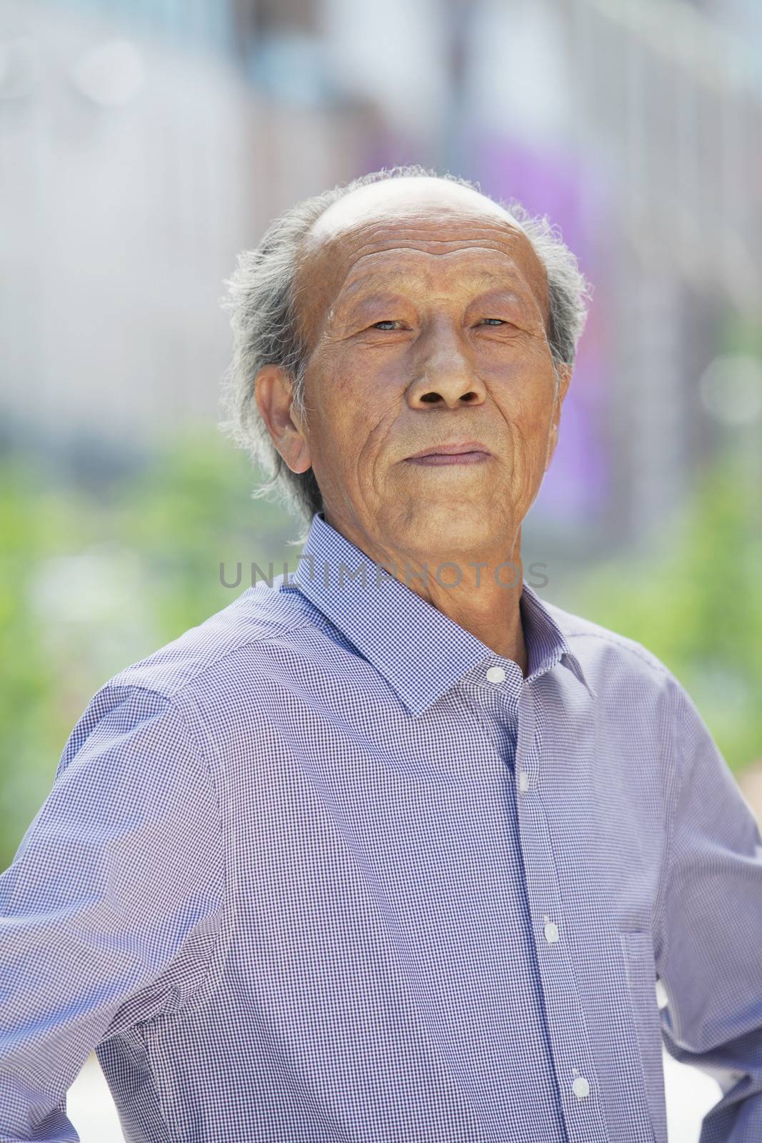 Portrait of senior man outdoors in Beijing by XiXinXing