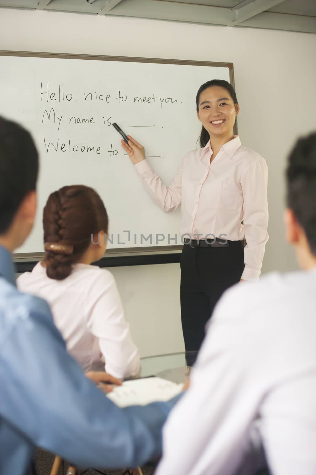 Office worker teaching coworkers