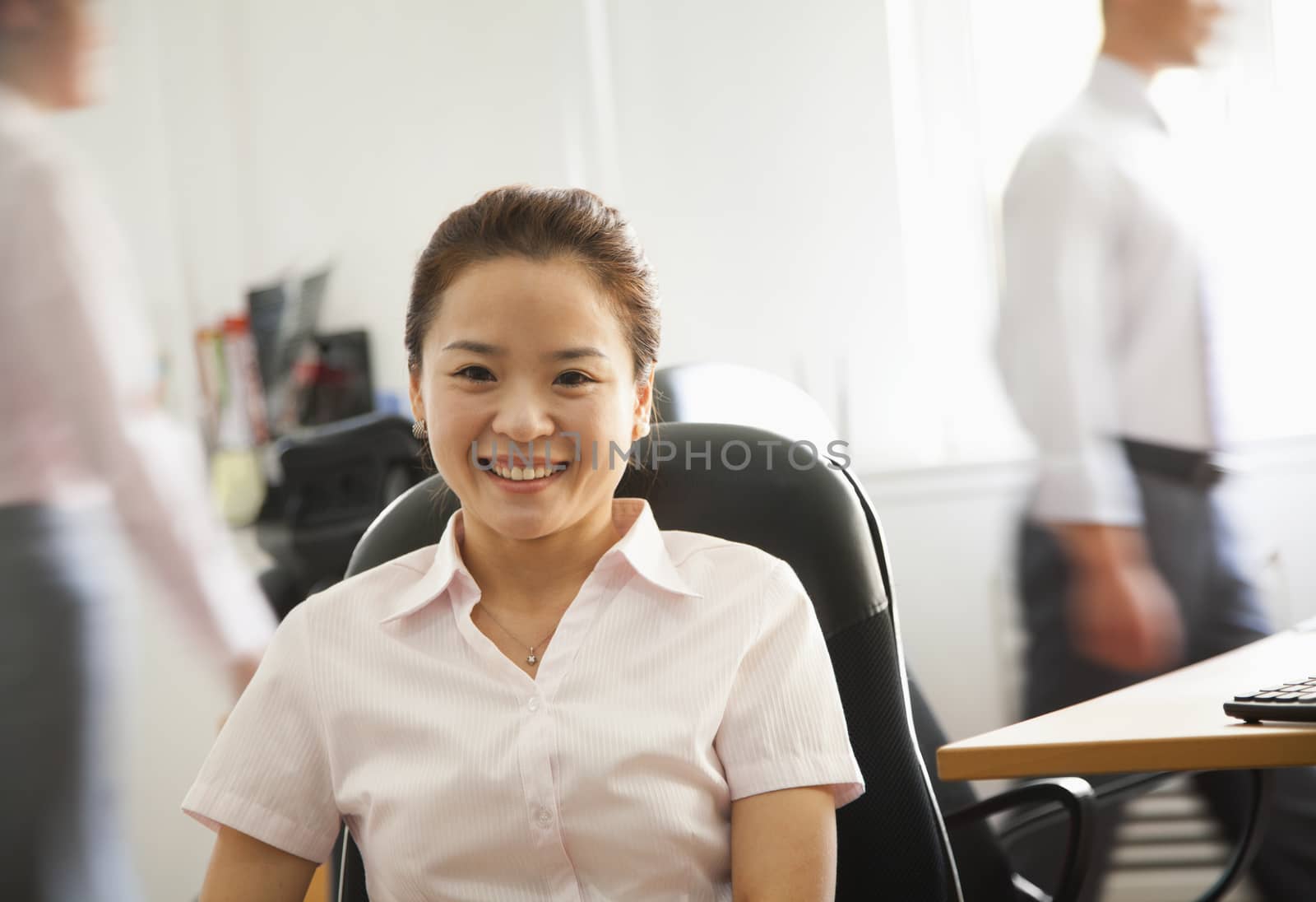 Office worker seating and smiling, portrait