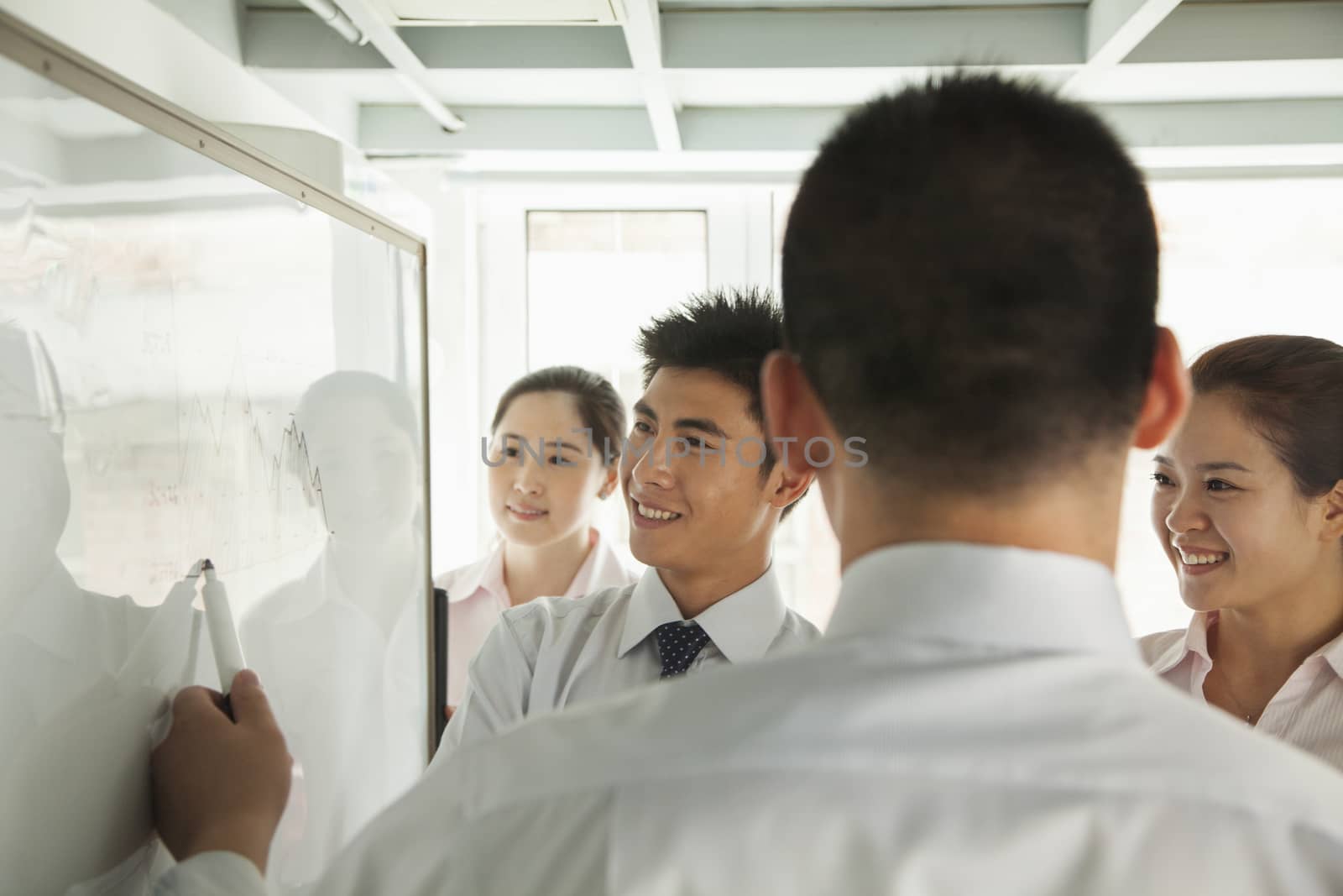 Workers looking on the diagram on the whiteboard