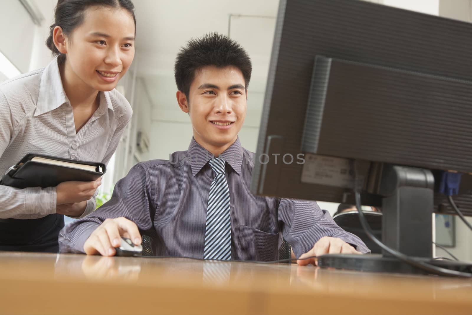 coworkers discussing the project over the computer screen