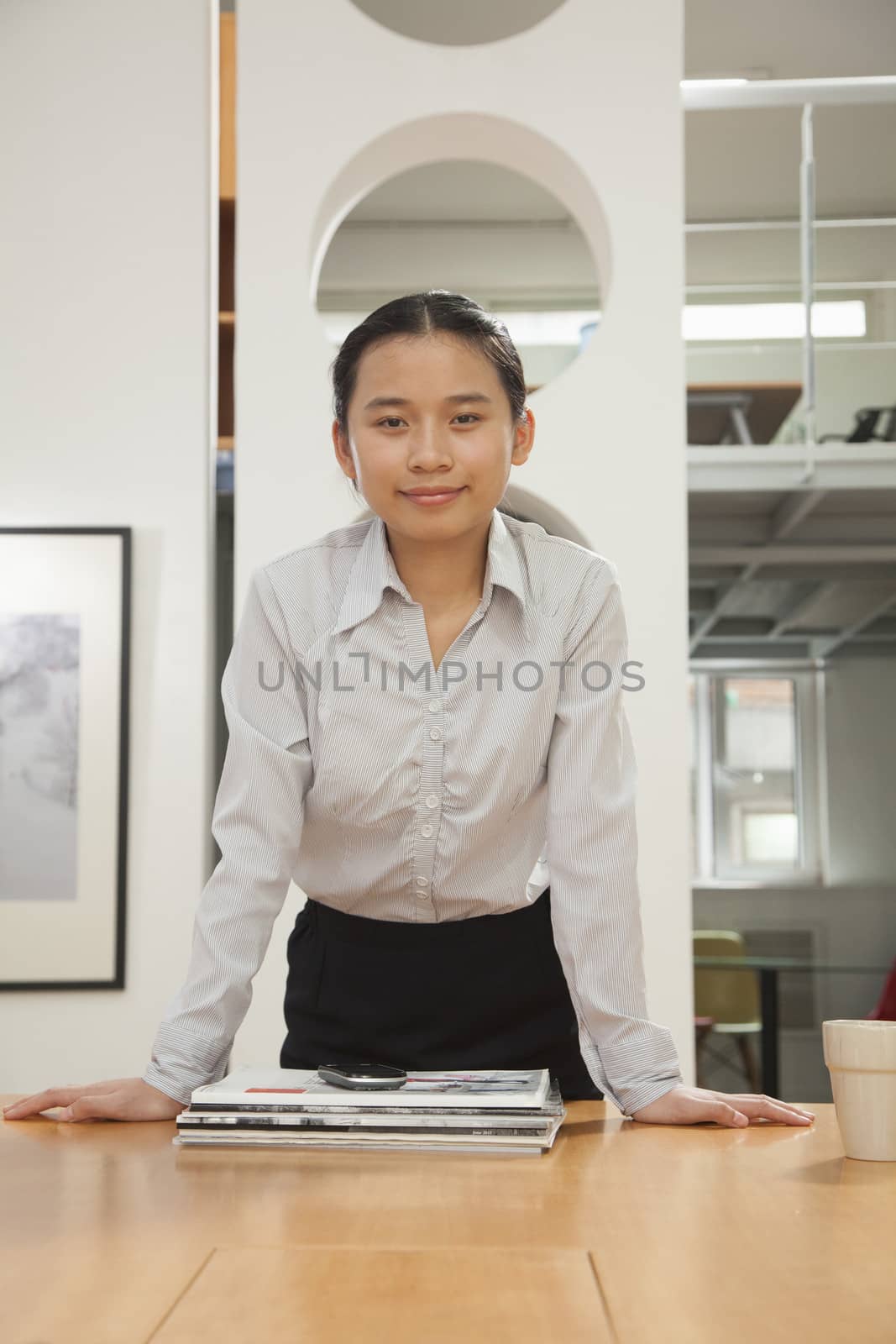 Young woman standing in the office, portrait