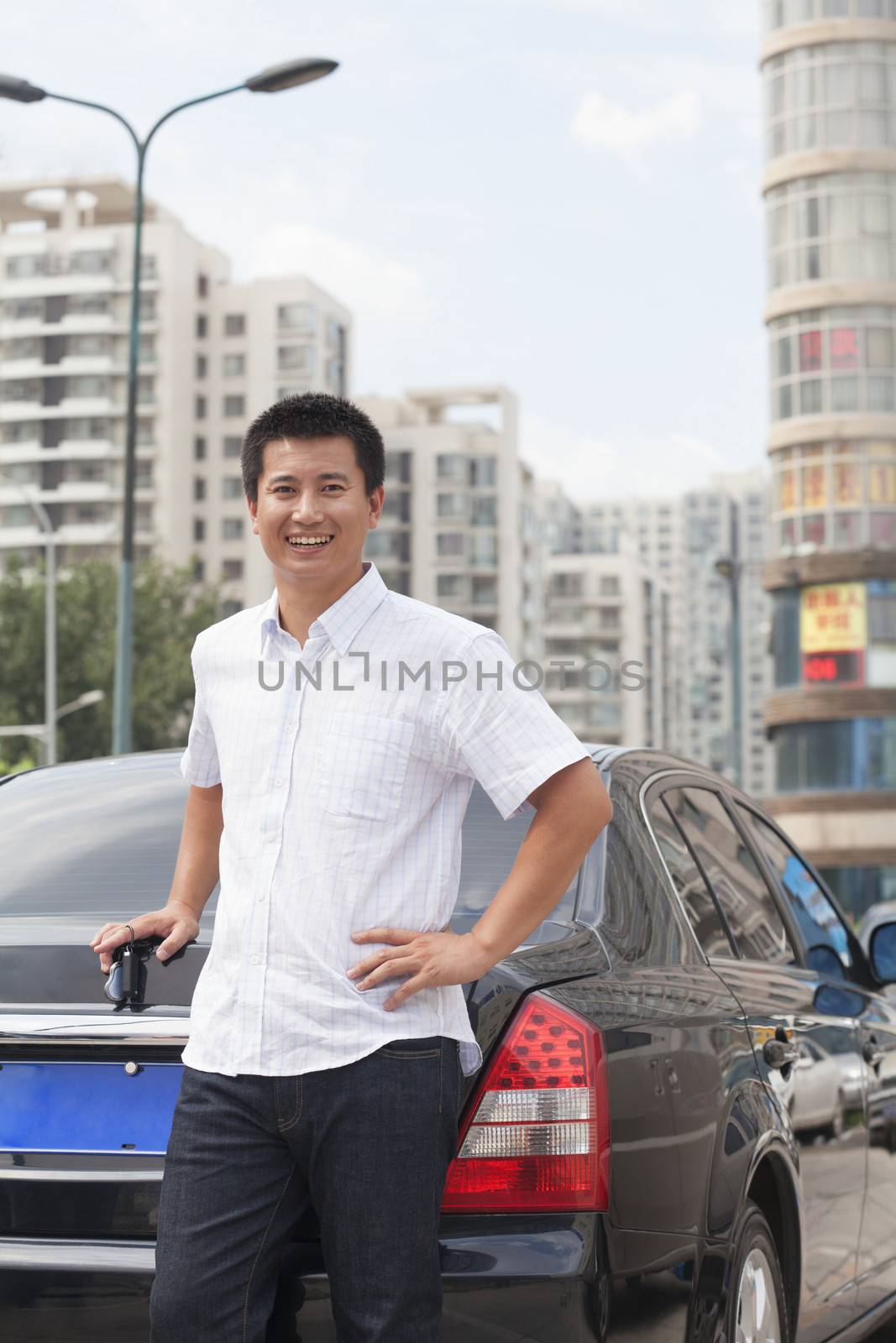 Man standing next to his car